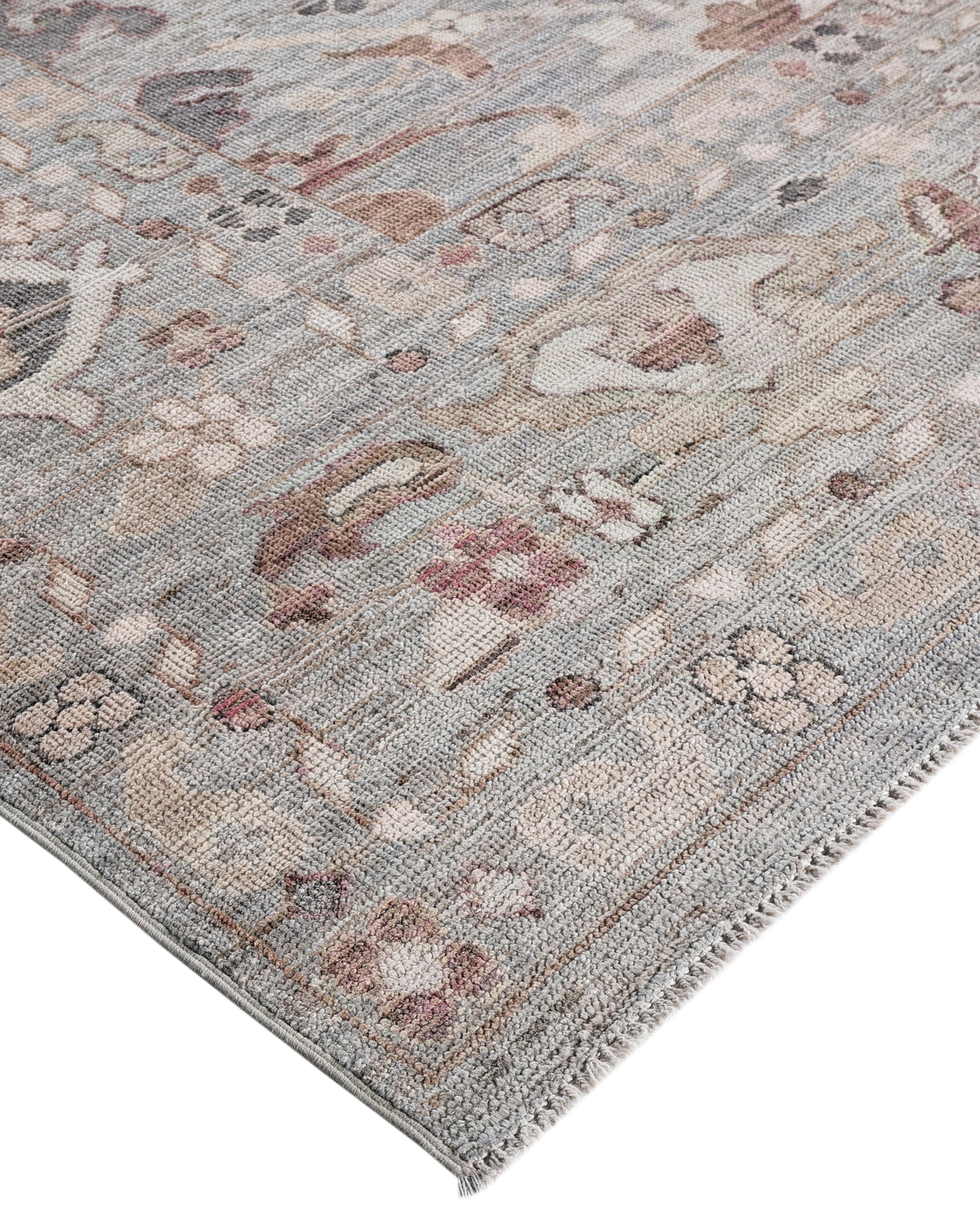 Oushak rugs are known for their soft, muted color palettes and large-scale, flowing designs. They often feature soft tones like beige, cream, gold, and light blue, with motifs that include palmettes, vines, and geometric shapes. These rugs are