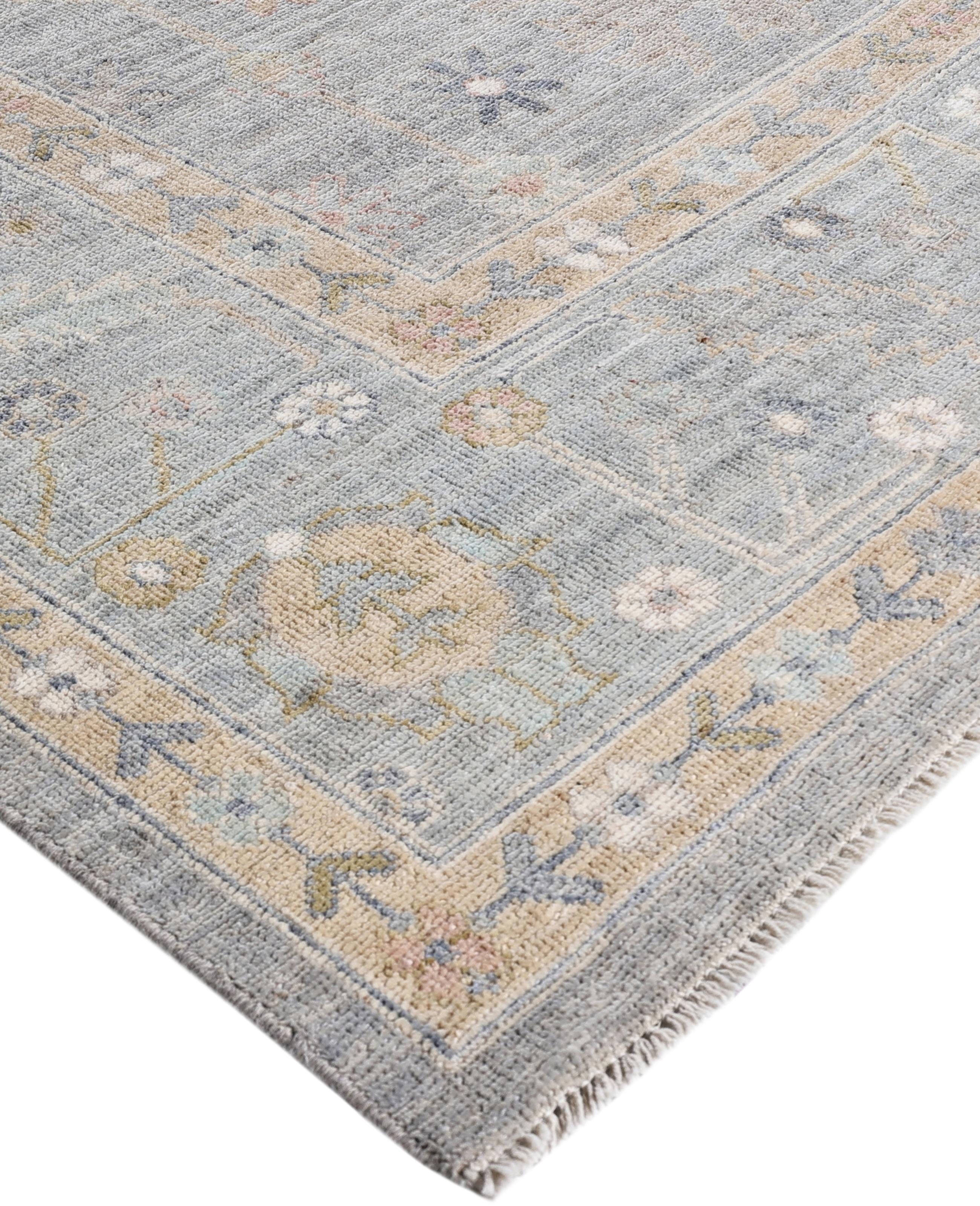 Oushak rugs are known for their soft, muted color palettes and large-scale, flowing designs. They often feature soft tones like beige, cream, gold, and light blue, with motifs that include palmettes, vines, and geometric shapes. These rugs are