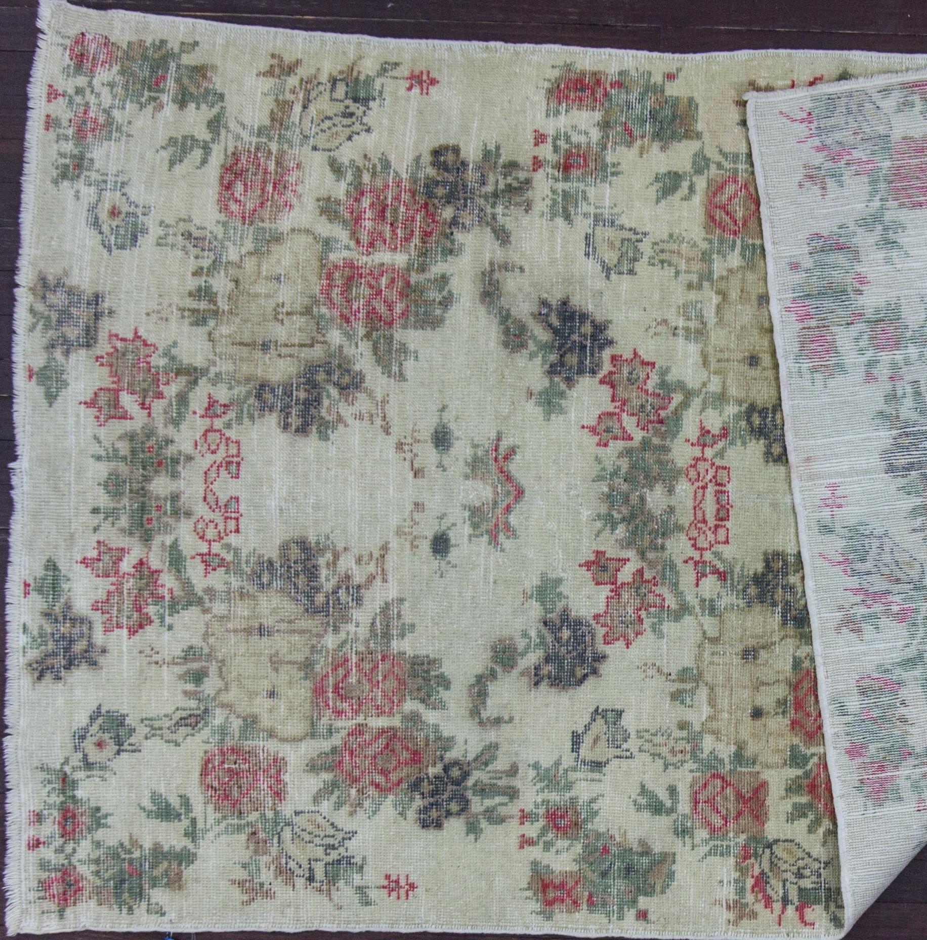 Antique handwoven wool Oushak rug with floral motif. Minor wear. Measures: 3'11