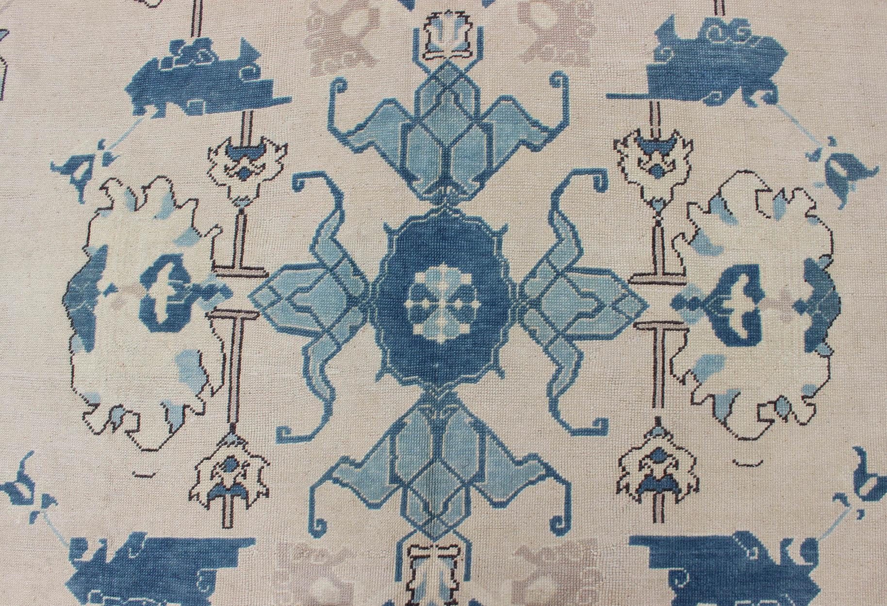 Wool Oushak Rug from Mid-20th Century Turkey with Blue and Cream Tribal Design For Sale
