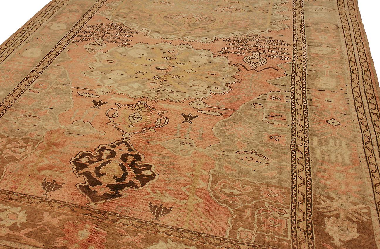 This Turkish Ushak Carpet is an exquisite work of art, and it will add a touch of luxury to any home. It was woven circa 1920, and it features a medallion field and wool pile. The soft color palette is perfect for any room, and the carpet will make