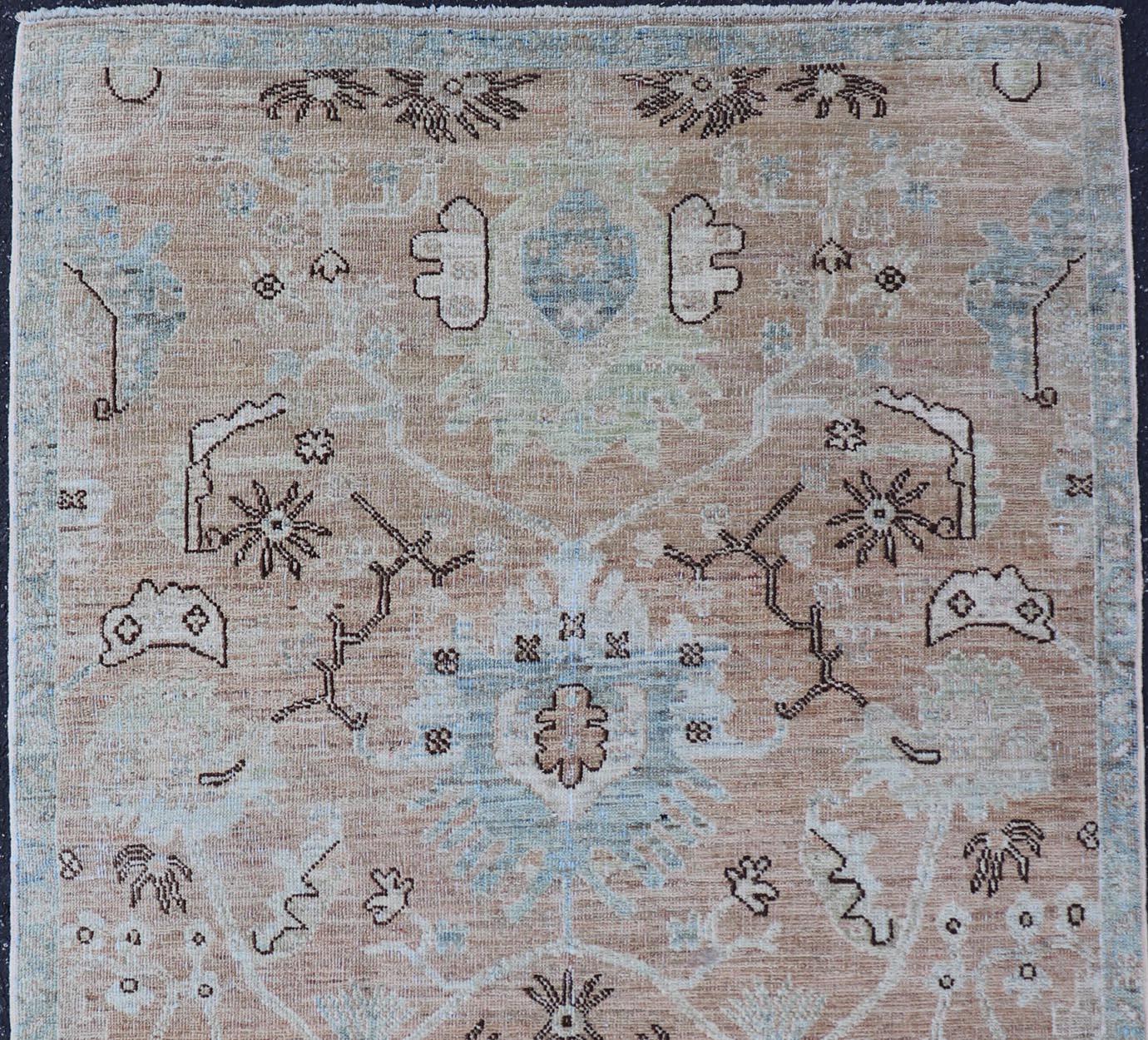 Measures: 3'3 x 5'0 
Oushak Rug with a Warm Apricot Base and Accents of Sky Blue, Ivory 3'3 x 5'0. Keivan Woven Arts. rug /AWR-527/ Early 21st Century, Turkish Oushak.

This modern Oushak rug features a beautifully woven design with a warm