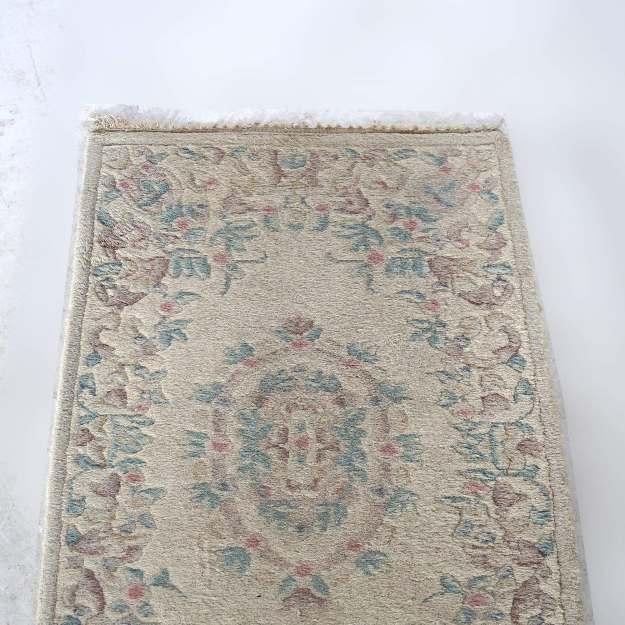 A Turkish Oushak style oriental long rug offers wool construction with triple medallion foliate design on cream ground, 20th C

Measures- 91''L x 27''W 