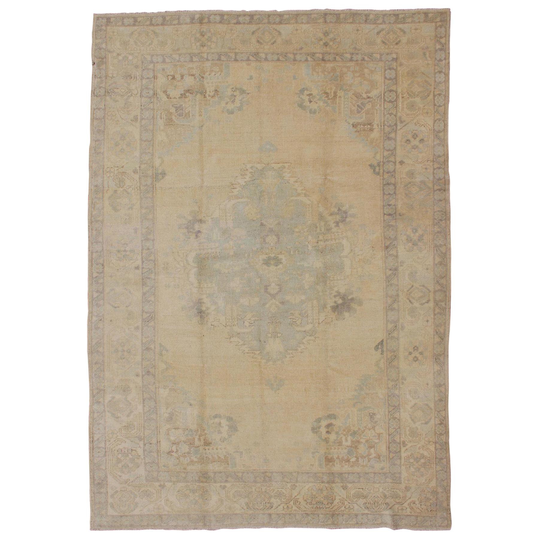 Oushak Vintage Turkish Rug with Faded Central Medallion Design in Cream Colors