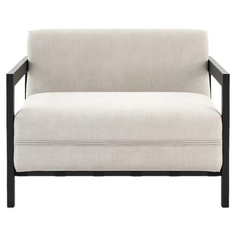 Contemporary outdoor armchair with upholstered seat and back cushions. 

Micro-textured stainless steel structure in black or white color. 
The back straps are offered in black or white. See attached images for finish options and fabrics color