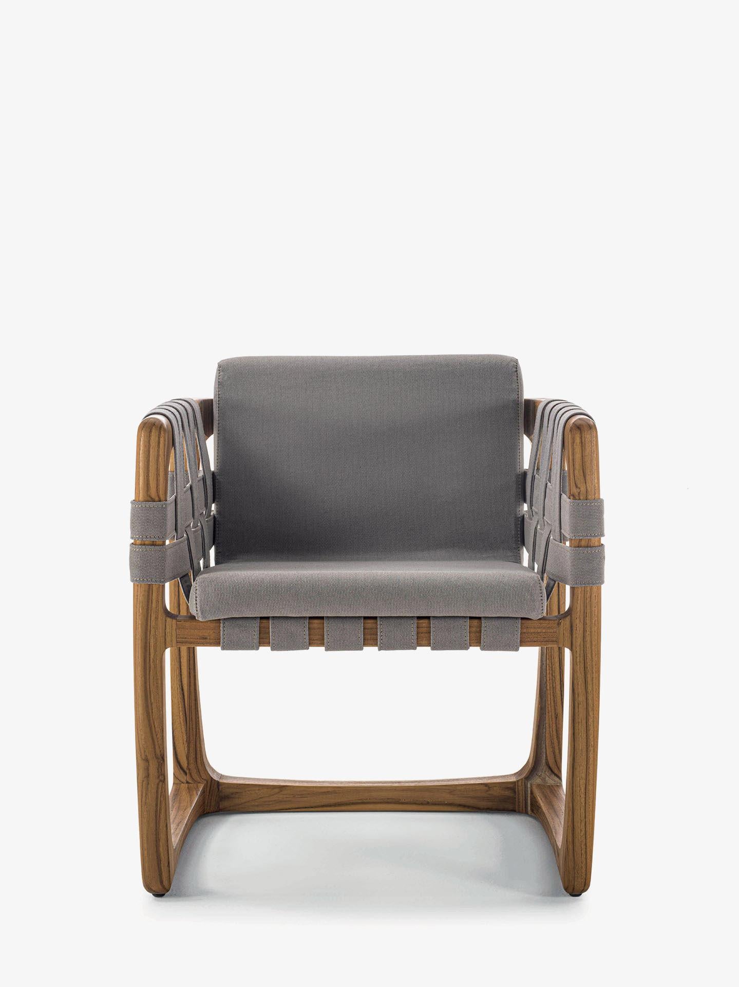 Padded chair with structure in solid teak wood turned, assembled and sanded completely by hand. An original detail are the strips of outdoor fabric running both under the seat, on the backrest and on the armrests.