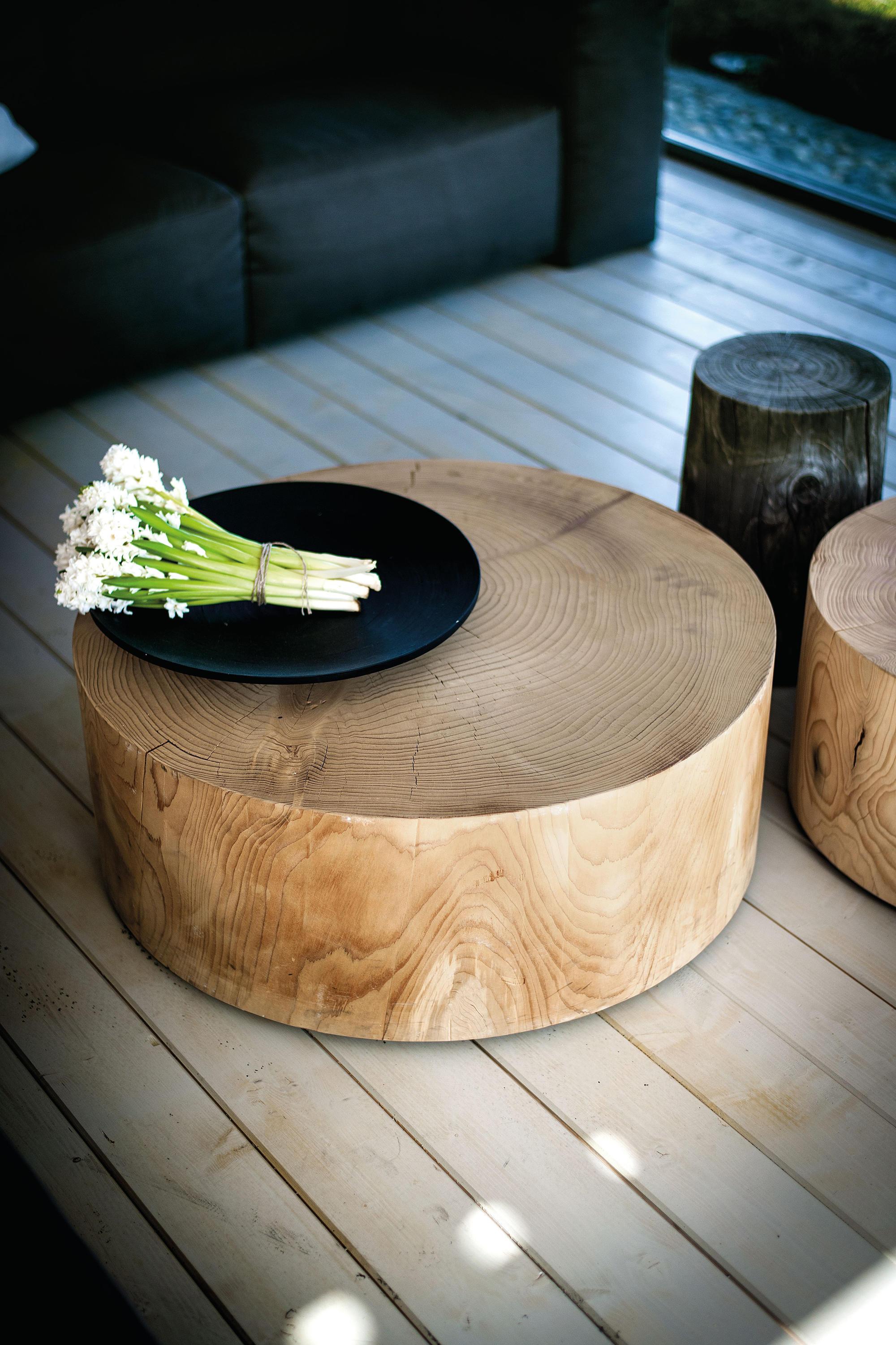 This coffee table celebrates the natural beauty and history of wood. Crafted from a single section of a scented cedar tree trunk, it showcases the tree's life story through its prominent, concentric growth rings.  The solid cedar construction not