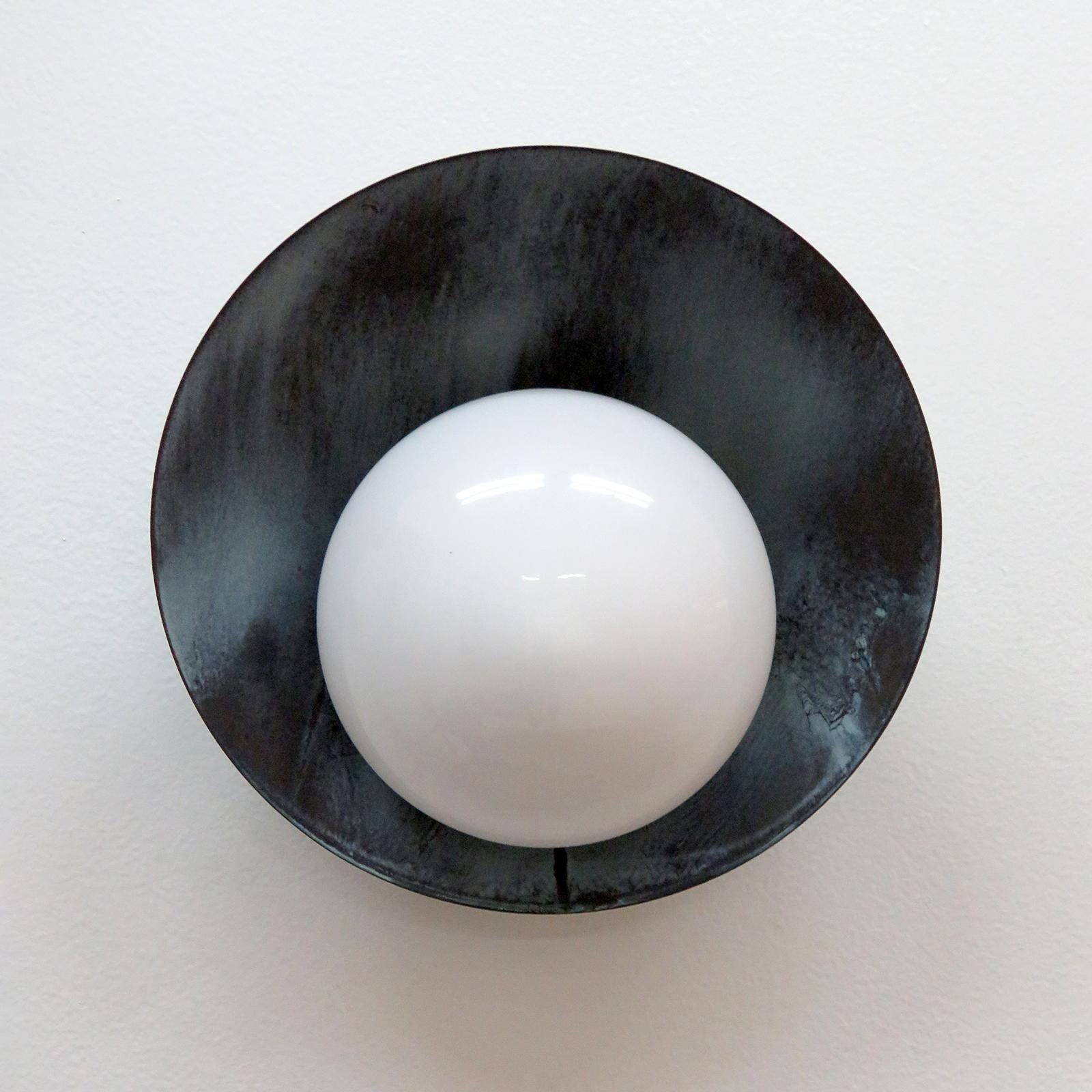 Elegant Concha outdoor wall lights designed by Gallery L7, handcrafted and finished in Los Angeles from American brass, with center opaline glass shade on a verde gris patinaed, brass disc. Available with gloss or satin glass shade. Due to the hand