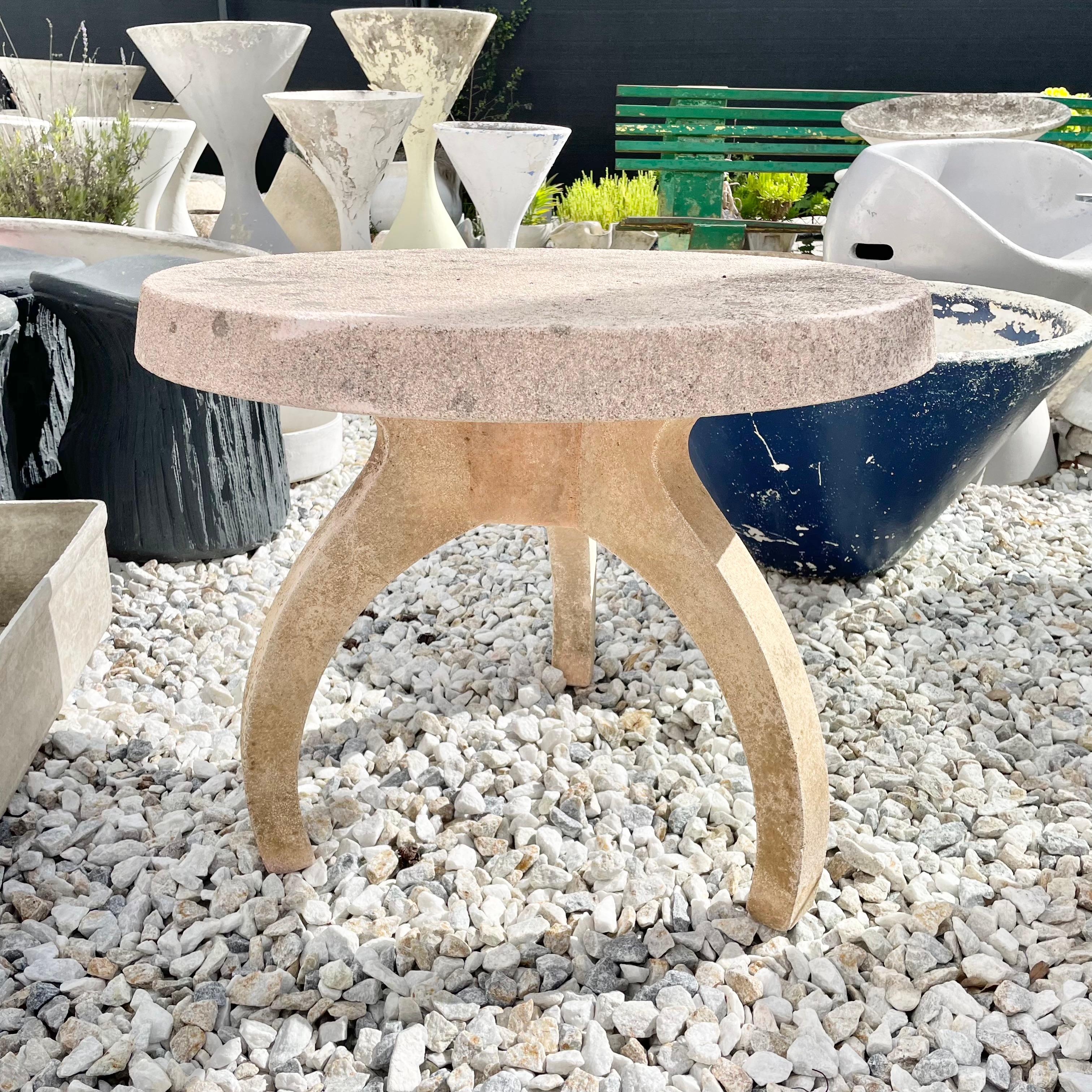 Substantial concrete table from France, made in the 1970s. Pink hue to the concrete with amazing patina from years outside. Entire table is cast in solid concrete which allows it to develop an incredible coloring. Very sturdy, heavy and well made.
