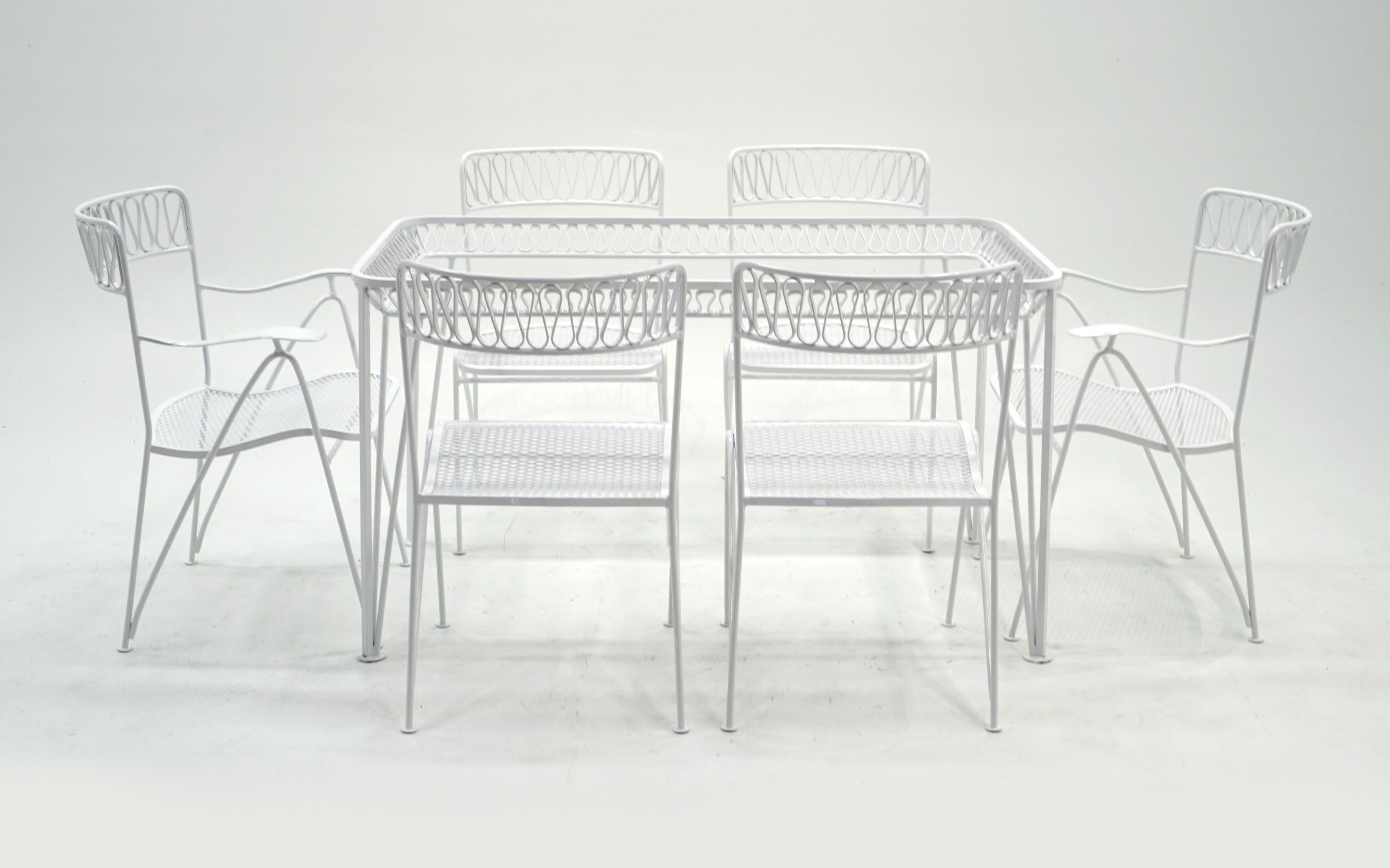 Patio/pool dining table and 6 chairs by John Salterini. Heavy wrought iron construction and just professionally media blasted and powder coated in a smooth satin white finish. The chairs are very comfortable. Sold without the glass top.
Measures:
