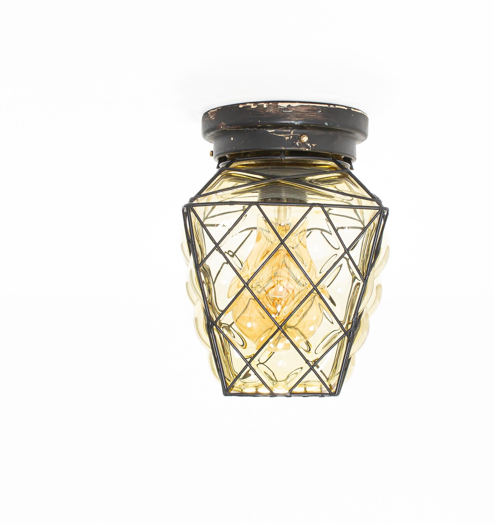 Wonderful flush mount ceiling lamp with shade in blown glass and frame in painted steel. Designed and made in Norway from circa 1950s first half. The light is fully working and in good vintage condition. The lamp is fitted with two  E27 bulb holders