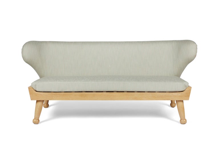 Winged outdoor sofa with low-profile design -- the newest addition to our Hayworth Collection. Upholstered back cushion and removable seat cushion, both made of outdoor dry-fast foam. Base and legs are made of bleached & lightly cerused outdoor wood