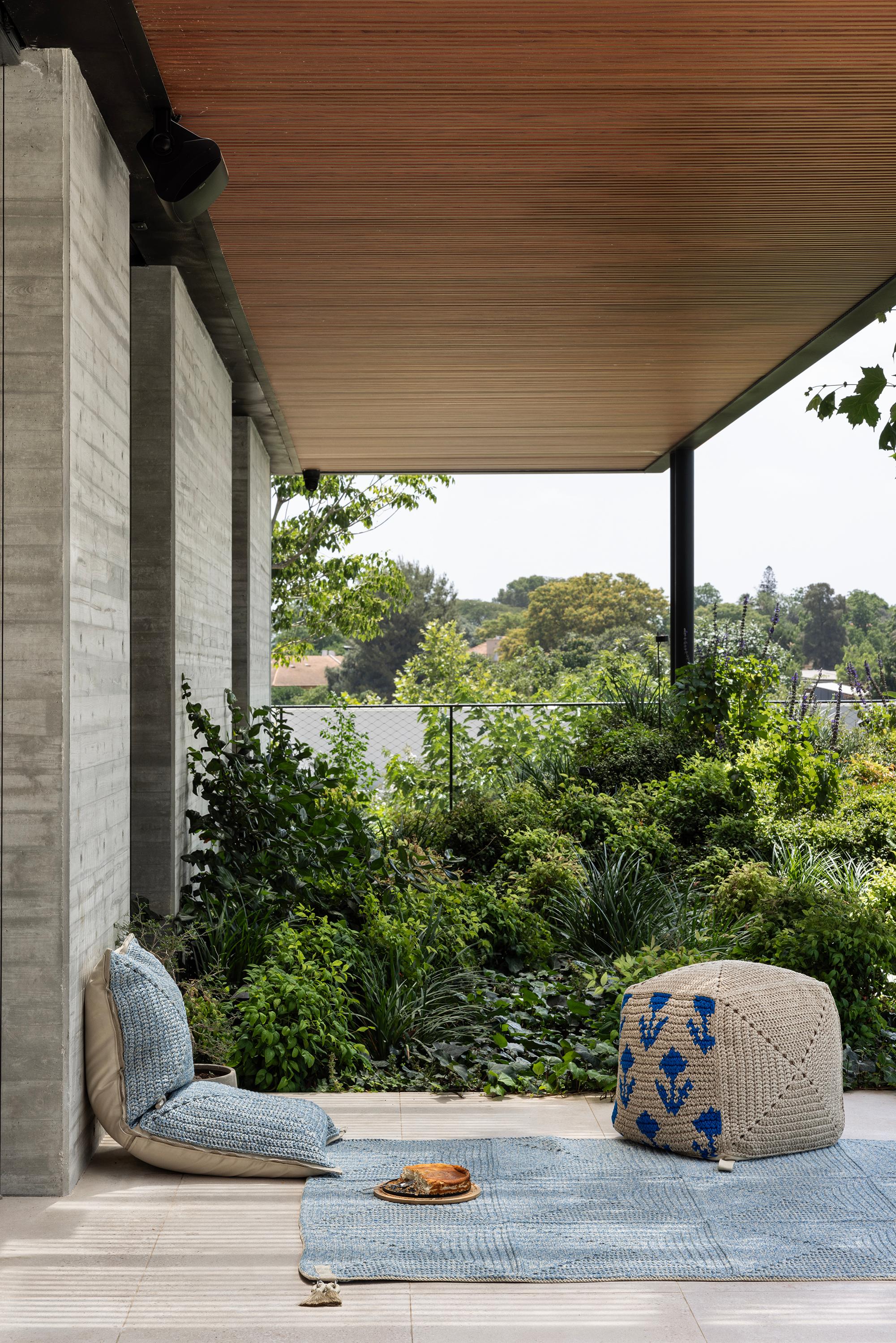 The Classic crochet granny square takes a contemporary twist in this outdoor rug. Large squares form the rug, framed with bespoke webbing. Handmade from UV protected bespoke iota yarn in earth tones, the textile is soft, yet durable and suitable for