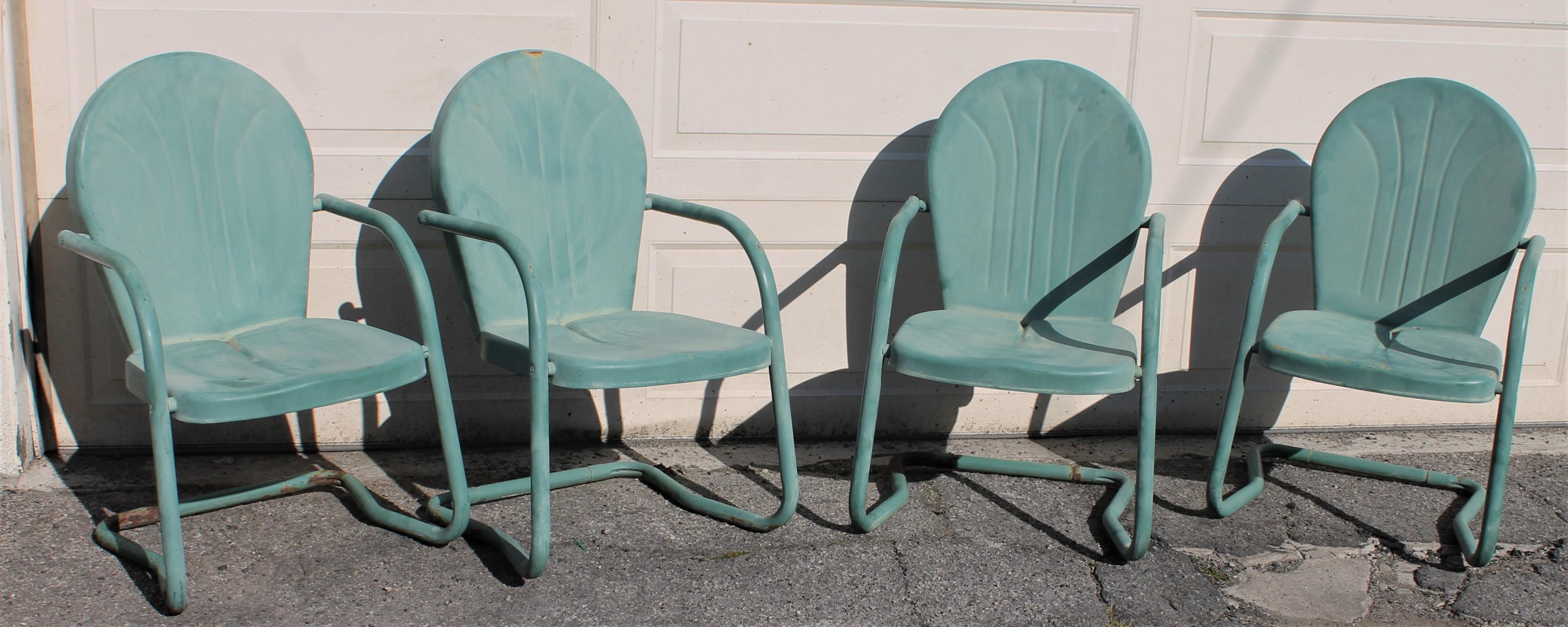 Midcentury original sea foam green painted metal set of four out door lawn or beach chairs. They are in great condition minor wear consistent from age and use. On 1stdibs site there is a rocking chair in the same surface and form.