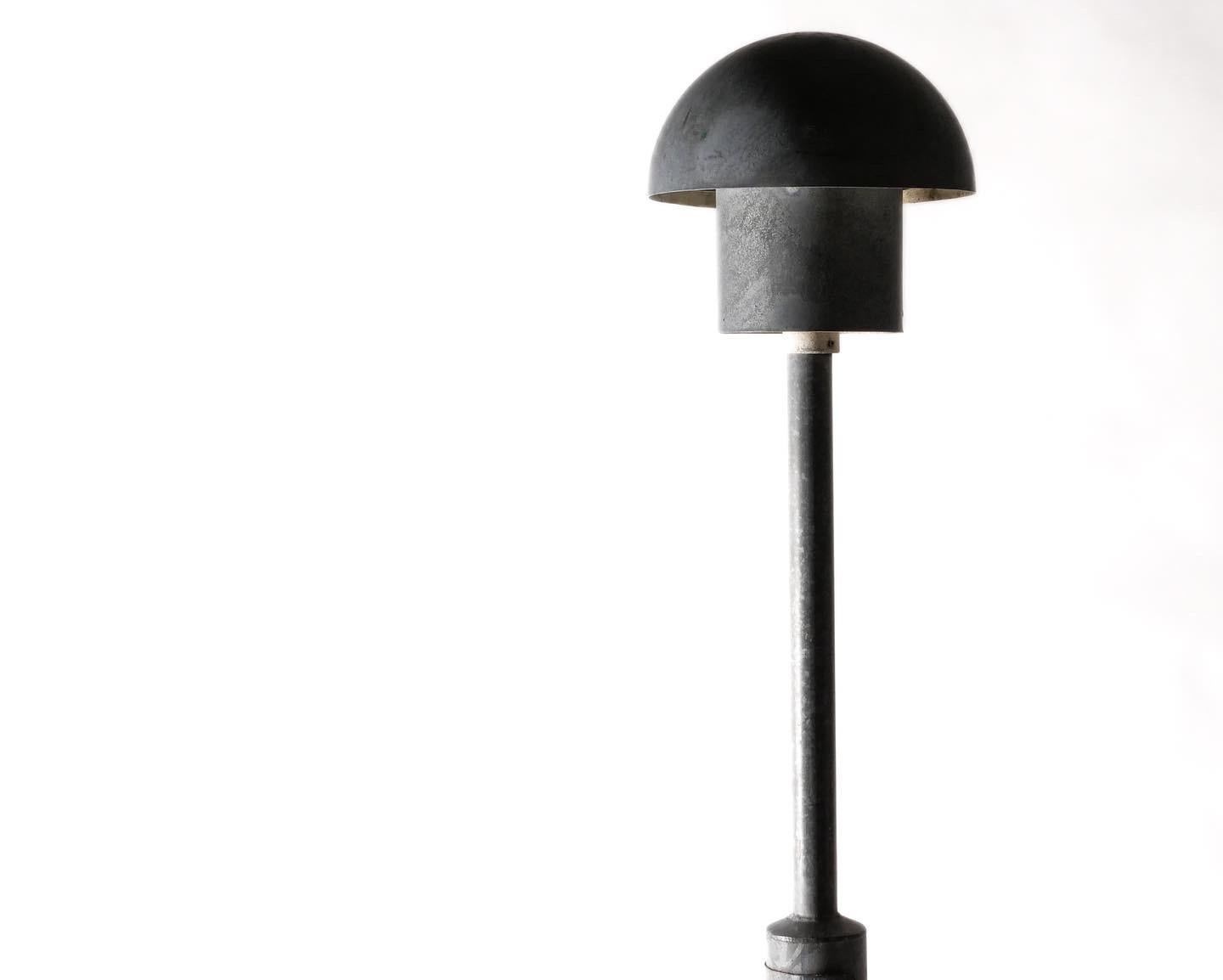 Four available. Large-scale in-ground lamps with original posts by Bjarne Bech for Louis Poulsen. Fantastic mushroom form shades diffuse light downward for excellent pathway illumination and overall ambient light. Will require hardwiring. Posts are