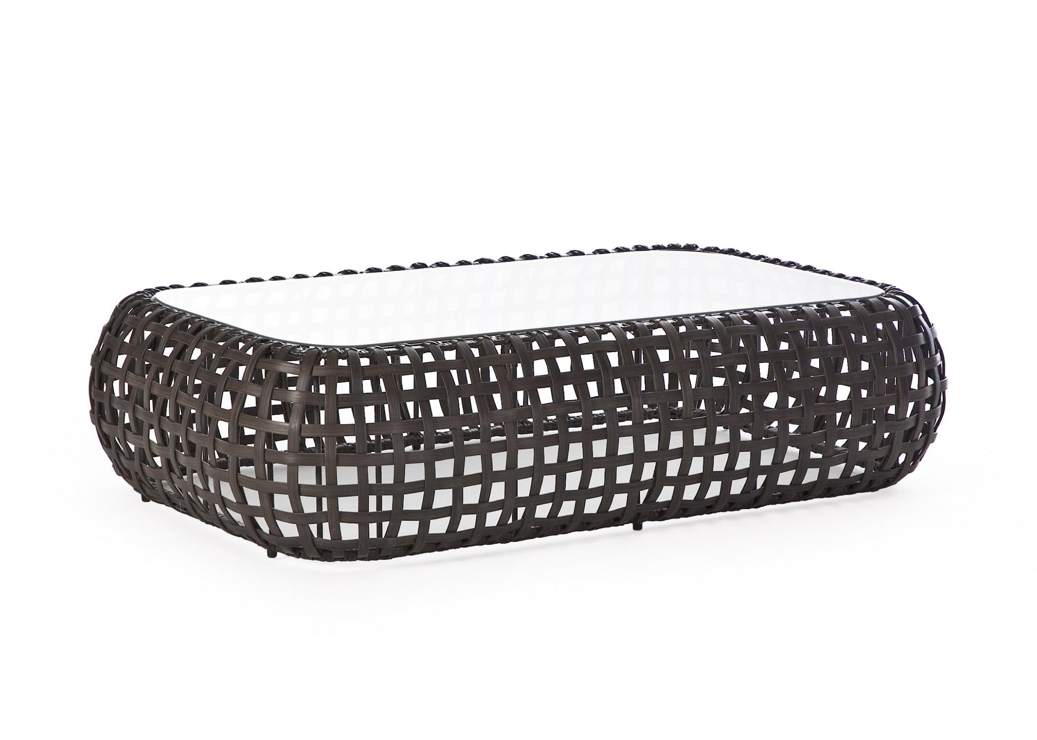 Outdoor Matilda coffee table by Kenneth Cobonpue.
Materials: Polyethelene. Aluminum. Glass. 
Also available in other colors and for indoors.
Dimensions:
Glass 71cm x 121cm x H 10mm
 Table 92cm x 142 cm x H 35cm.

The same principle of a woven