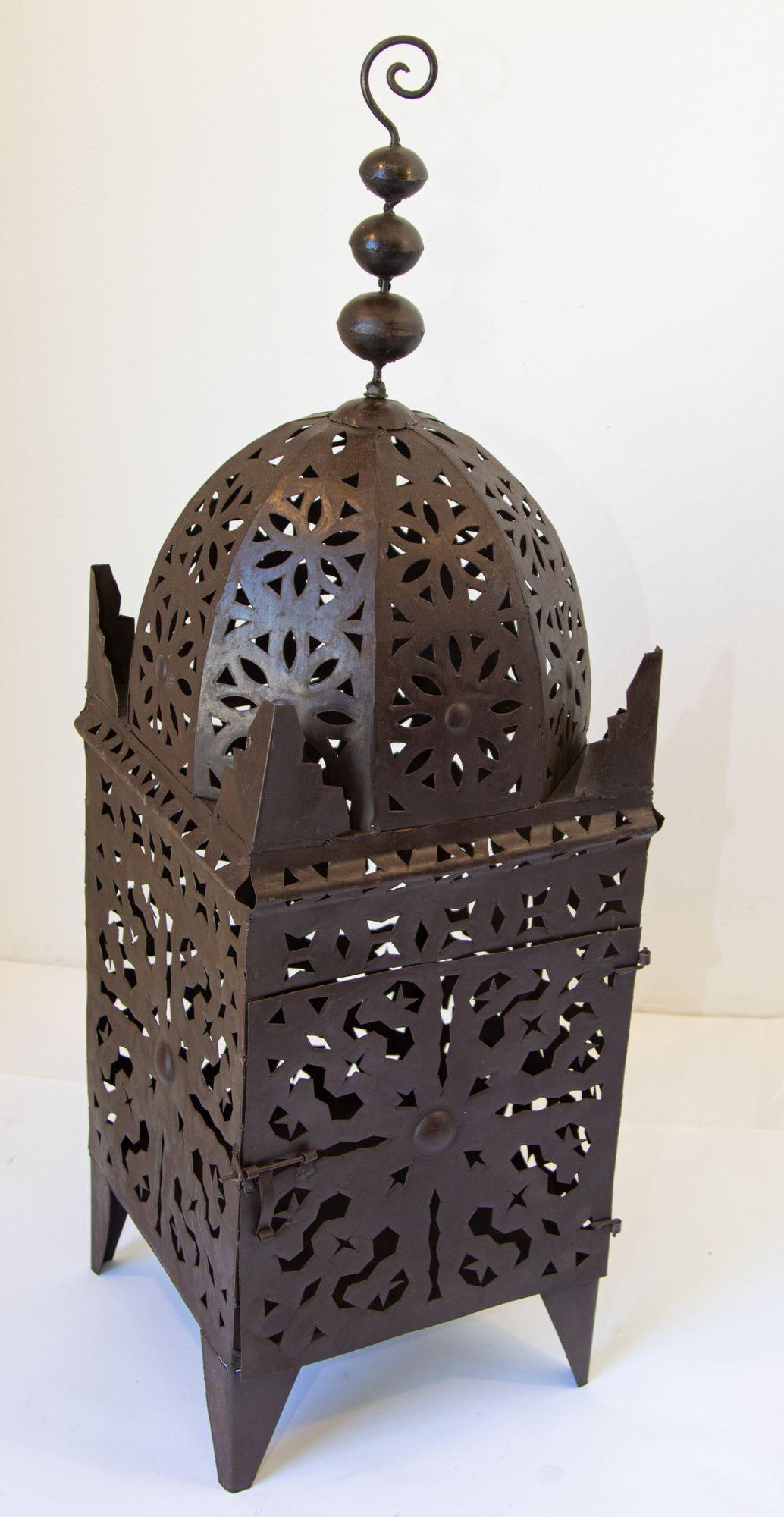 Outdoor Moroccan hurricane metal candle lantern.
Moroccan Moorish metal candle lantern.
Hurricane candle lamp handcrafted in Morocco by artisans, metal hand-cut openwork and hammered with Moorish designs, open in front for use with pillar