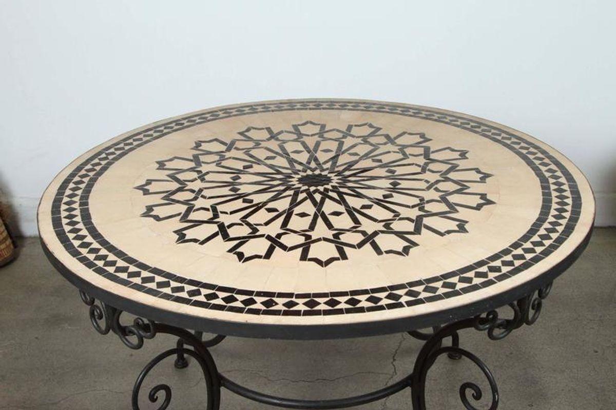 Handcrafted round Moroccan outdoor mosaic tile table 47 in. diameter on iron base.
Classic and elegant Moroccan outdoor mosaic tile table sit on a black wrought iron base.
Handmade in Morocco, the artisans from Fez used the Classic Moroccan cut