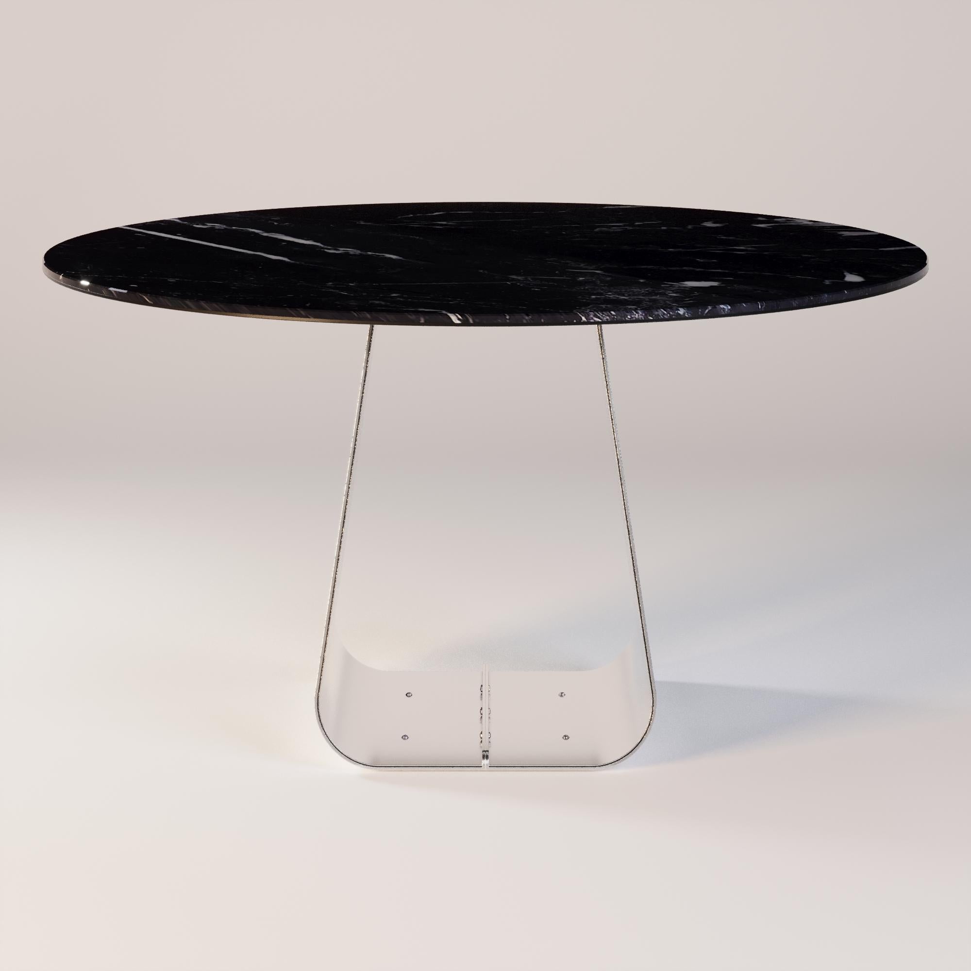 Orizon Round Dining Table 

A dining table where light meets stone and metal. The marble top reveals its unique texture, capturing every nuance of natural light. The round shape invites intimacy, while the legs with subtle metallic details reflect a
