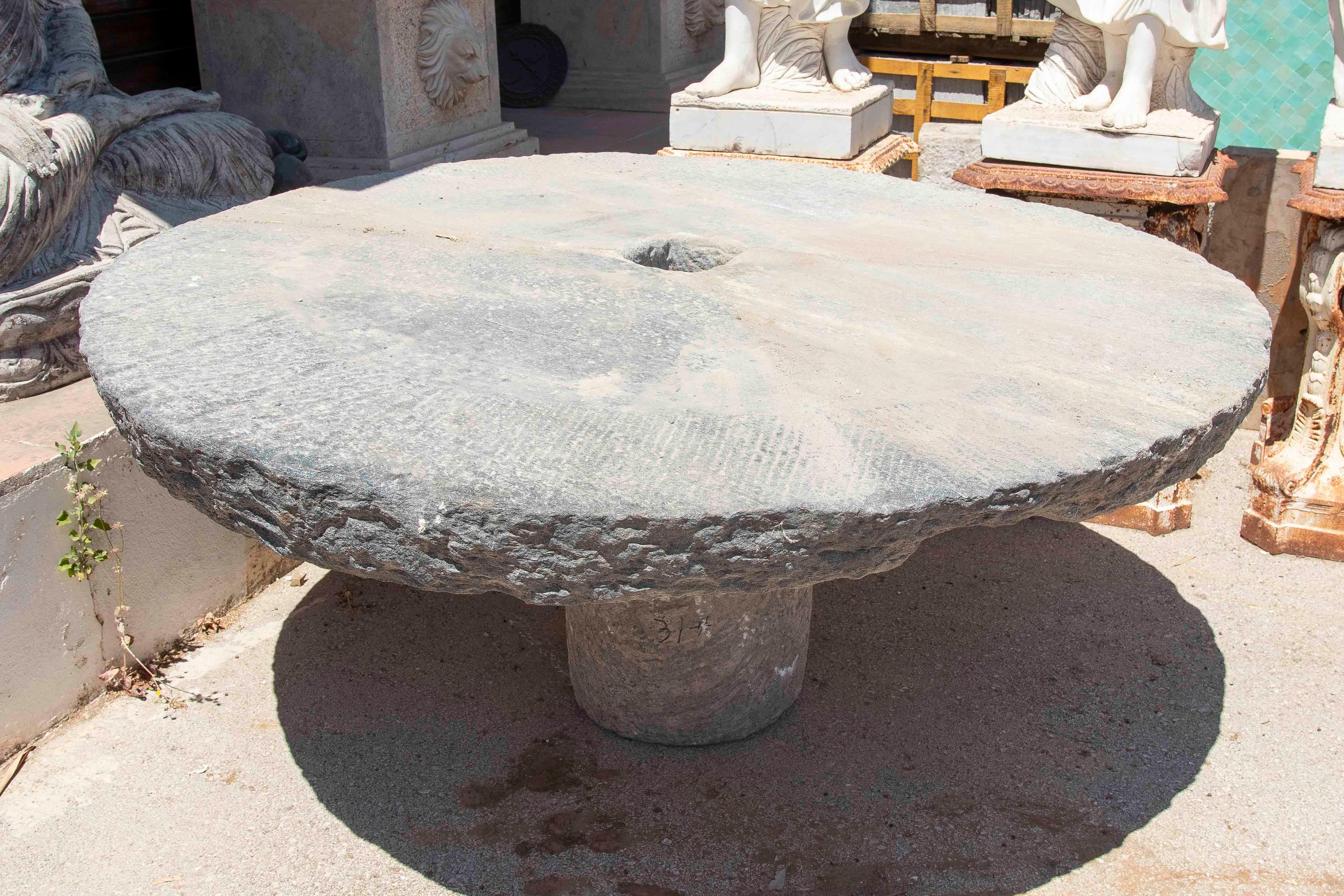 Outdoor Table with Antique Millstone and Cylindrical Base Made of Natural Stone For Sale 8