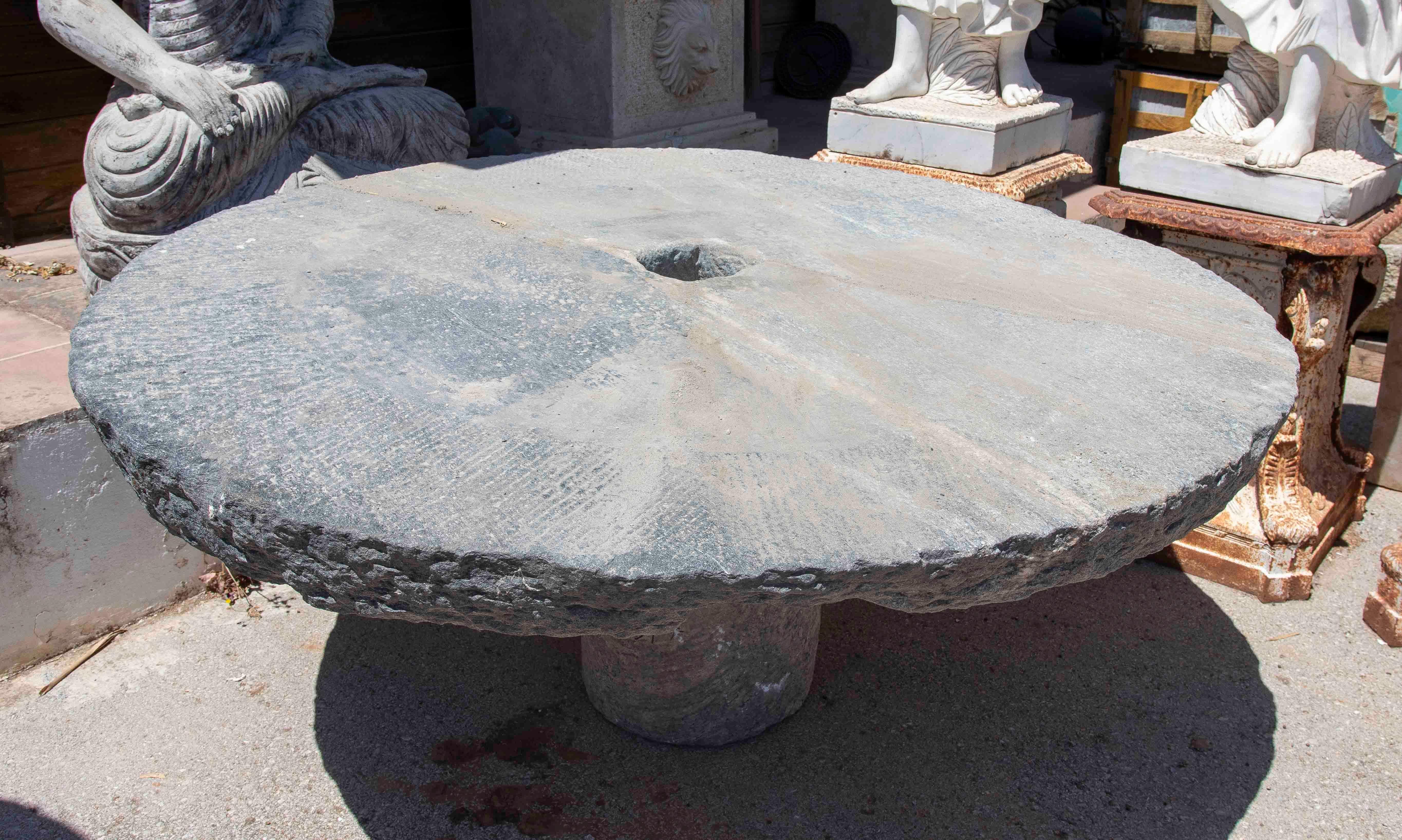 Spanish Outdoor Table with Antique Millstone and Cylindrical Base Made of Natural Stone For Sale