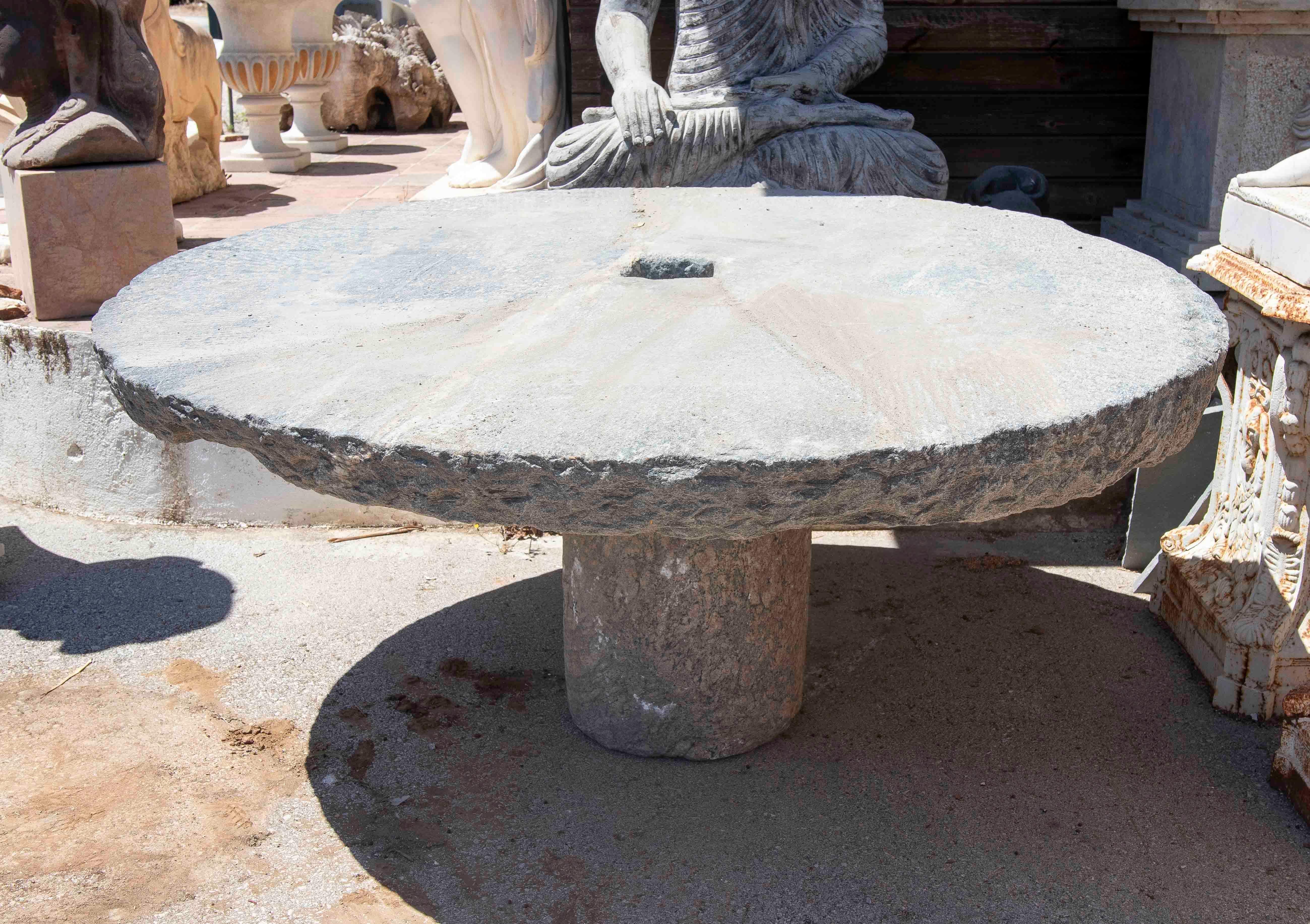 Hand-Carved Outdoor Table with Antique Millstone and Cylindrical Base Made of Natural Stone For Sale