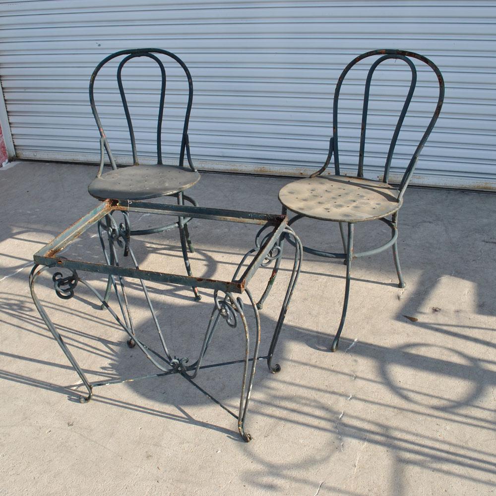 A set of outdoor furniture consisting of a table and two chairs.  The glass insert top is not included.   

The table measures 22
