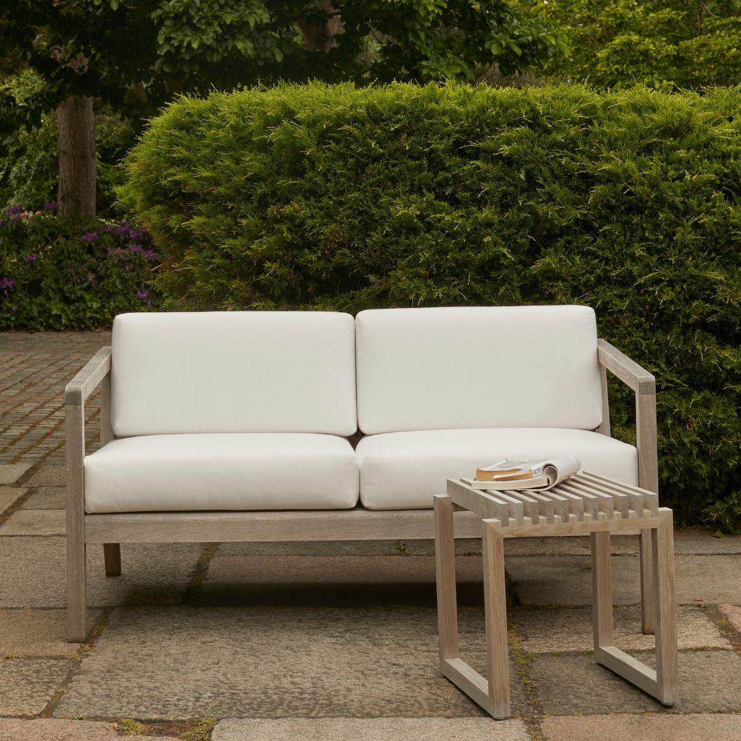 Outdoor 'Virkelyst' 2-seater sofa in teak and white fabric for Skagerak

Skagerak was founded in 1976 by Jesper and Vibeke Panduro, who took inspiration from their love of Scandinavian design and its rich tradition. The brand emphasizes