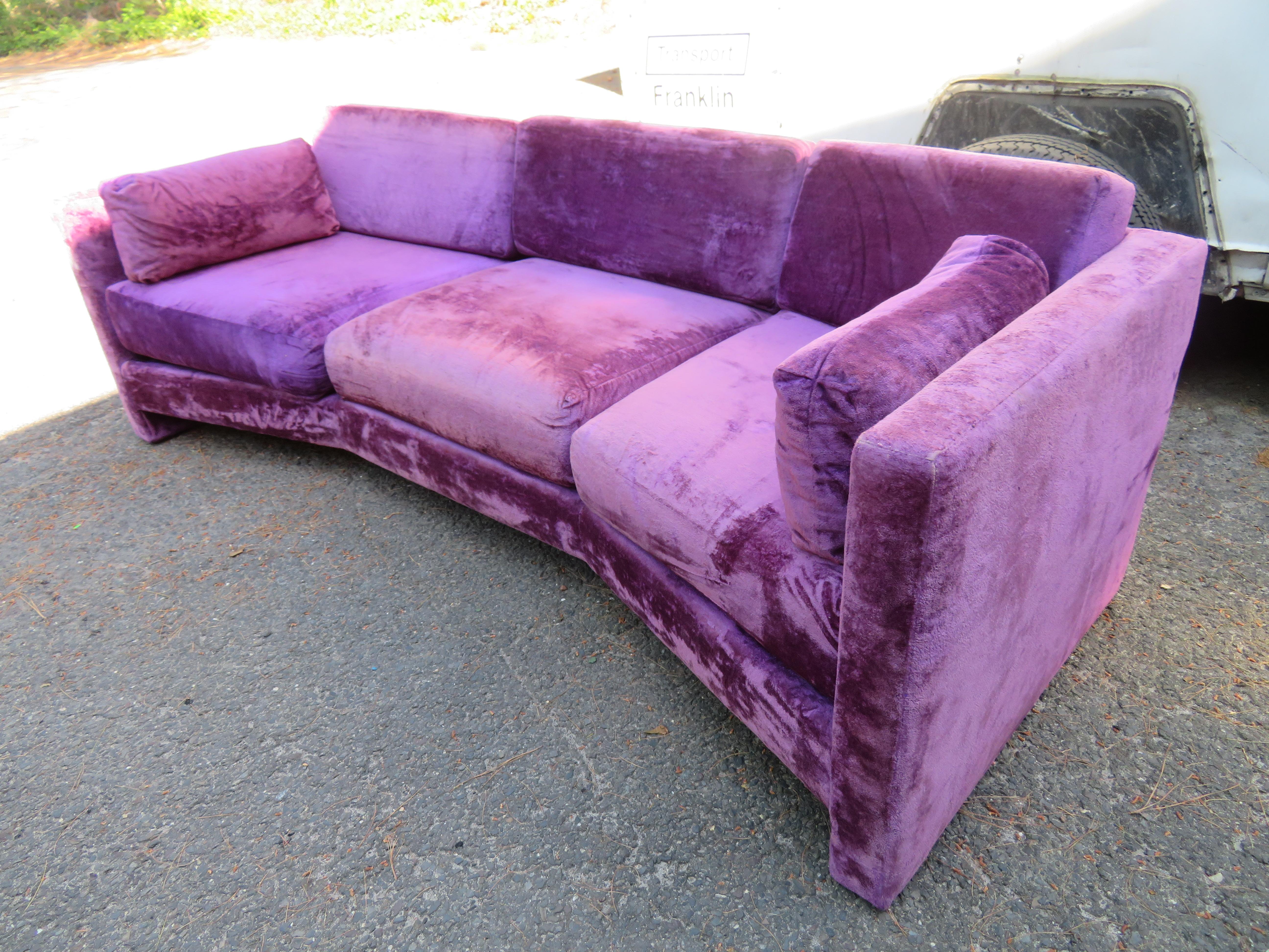 Outrageous Harvey Probber style purple velvet curved back sofa. This super sexy sofa retains its original shimmery purple crushed velvet in very presentable condition. It shows some minor wear to the arms but the vintage vibe this sofa has is beyond
