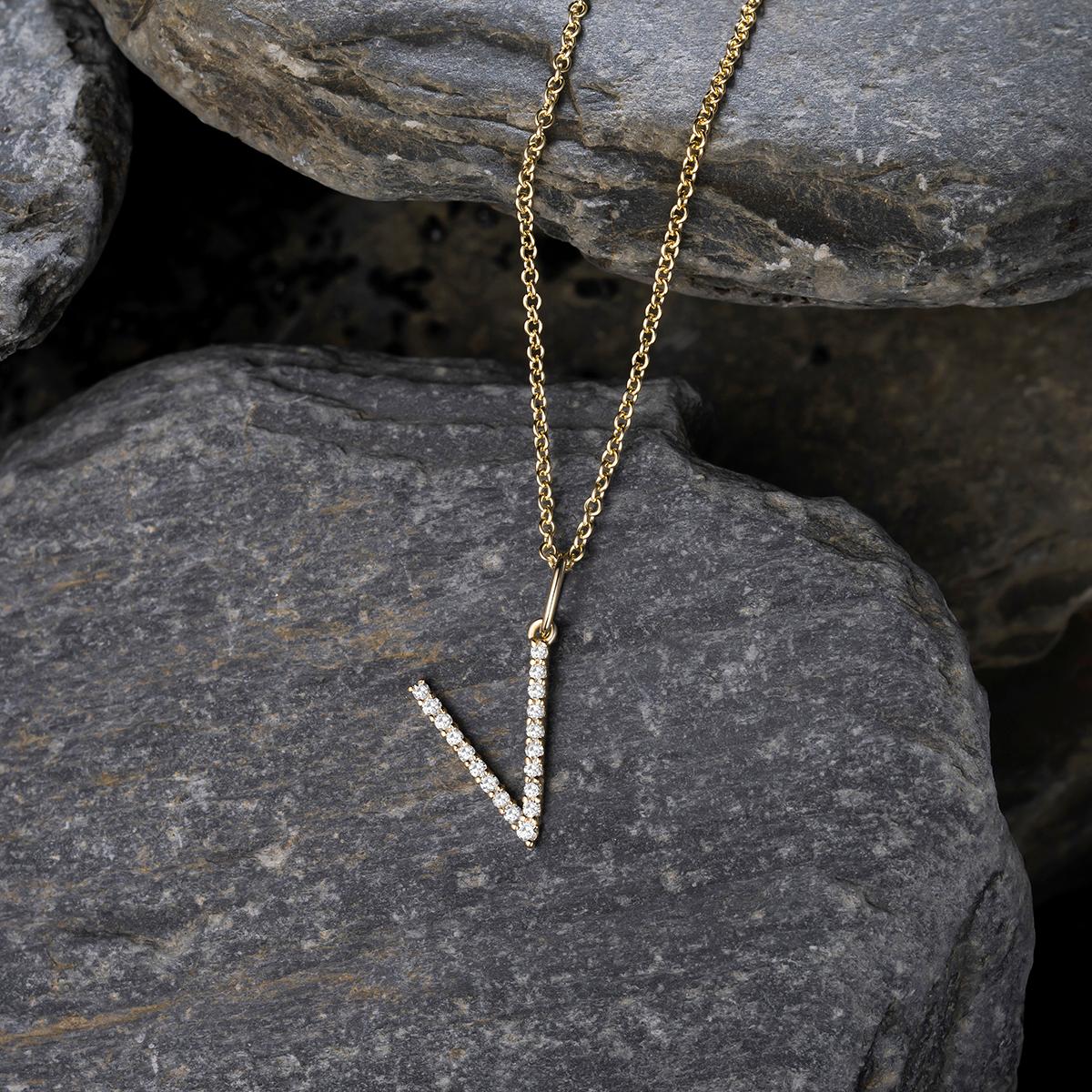 Add a touch of personalized elegance to your style with this stunning Diamond Letter V Pendant 14K Yellow Gold Necklace. Crafted with natural diamonds, this delicate piece shines beautifully, making it perfect for everyday wear or special occasions.