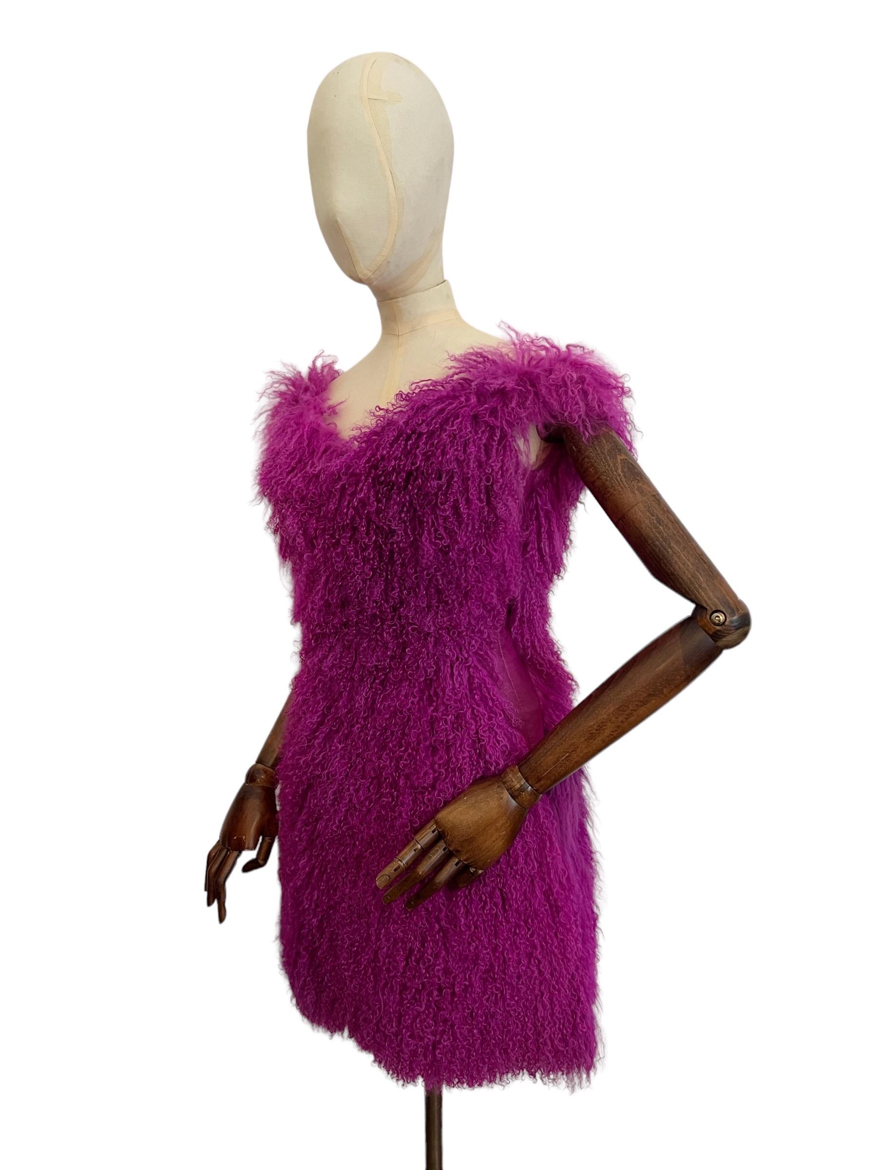 VERSUS Versace 2012 Runway dress in Magenta / Purple Mongolian Lamb Fur.

This Outrageous Fluffy dress is made from 100% Mongolian Lamb fur with butter soft leather Panelled sides, The back completely zips open and as you may see photographed can be