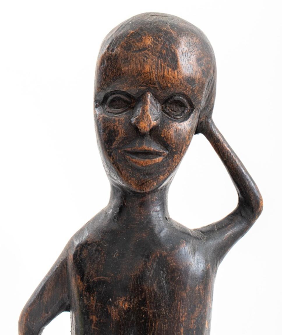Outsider Art carved wooden figure, possibly of an African-American subject (possibly an African carving) of a man with his hands in a quizzical pose. 

Dimensions: 13.5