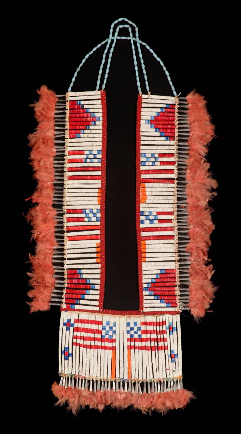 Outstanding, native American, quilled, tin cone and feathered breastplate with an interesting beaded strap, probably Lakota Sioux, circa 1870-1880 :

American Indian breastplate, with staves made of parfleche and wrapped with porcupine quill,