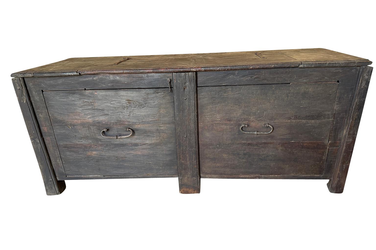 An outstanding 17th century primitive Credenza from the Piedmont region of Italy. Very soundly constructed from walnut and oak with a lifting top surface and 2 large doors. A tremendous storage piece perfect for any rustic or modern environment. 