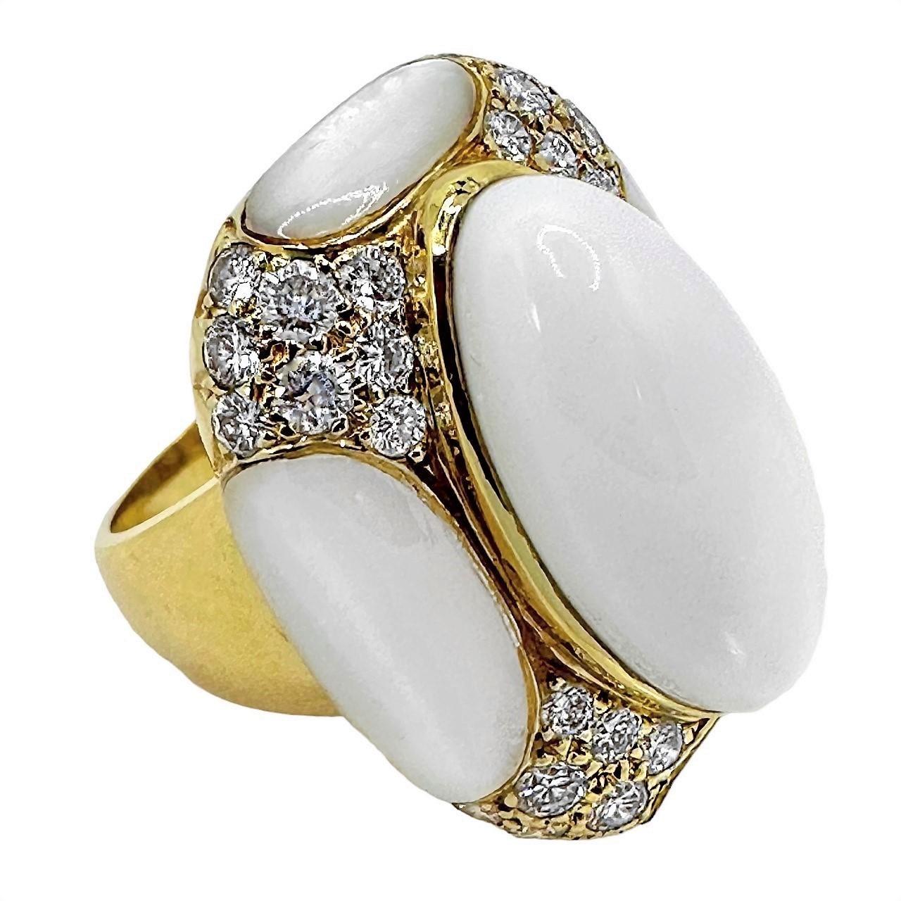 This beautiful and unusual vintage Albert Lipten fashion ring, crafted in 18K yellow gold, is visually seductive. The combination of the white onyx cabochon in the center next to mother of pearl sections and diamond pave corners, creates a unique