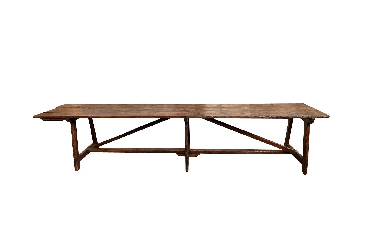An outstanding and grand scale 18th century Italian farm table from the Piedmont region. Soundly constructed from richly stained pine with attractive cross stretchers and a single drawer to one end. A perfect table to host a large gathering.