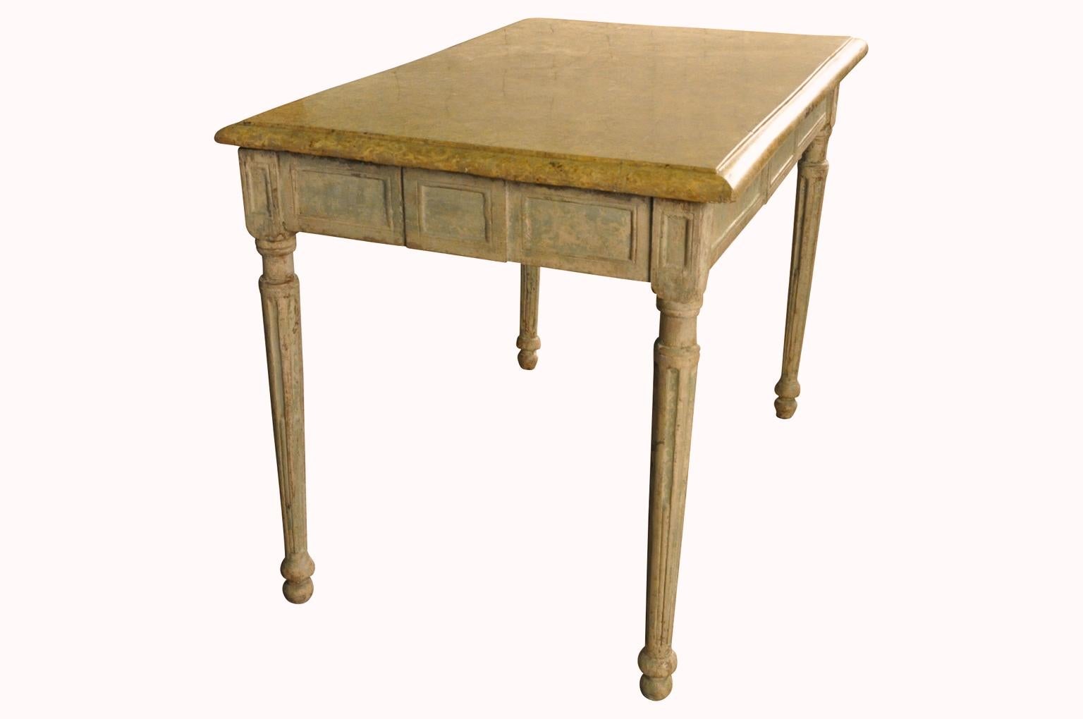 An outstanding 18th century period Louis XVI side table - writing table in painted wood with marble top. Beautifully constructed with fluted legs and molded apron panels. Tremendous patina. Perfect as a bedside table, side table or vanity.