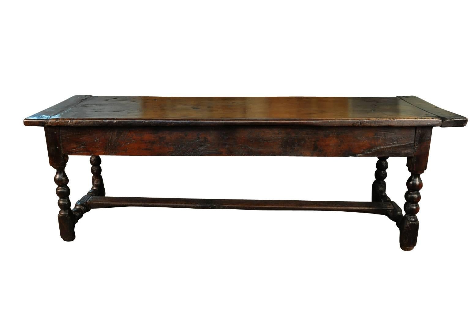 An outstanding 18th century Spanish trestle console table. Masterly constructed from walnut with an exceptional solid board top. There is a single drawer to one end with a very handsome carved fascia. Sensational patina - very deep and luminous.