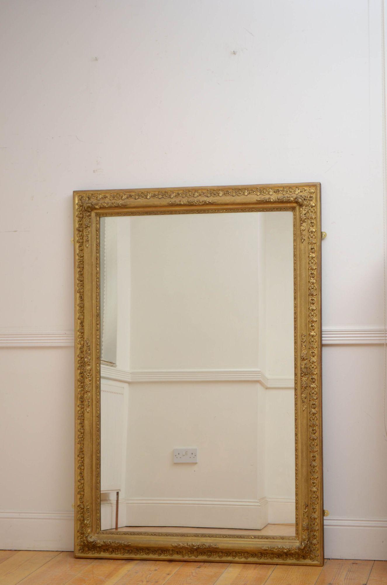 Sn5439 Outstanding French giltwood wall mirror of versatile form, can be positioned horizontally or vertically, having original glass with minor imperfection in gilded frame decorated with scroll carving to inner edge, reeded column with floral