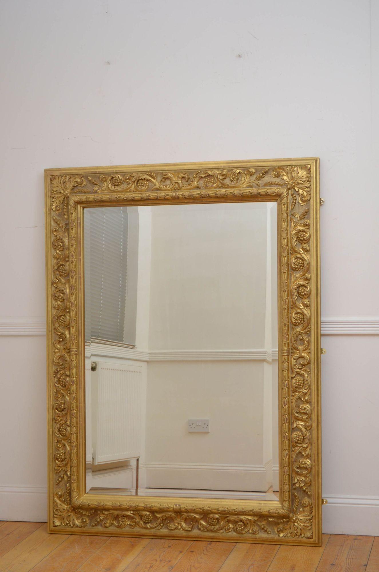 Sn5438  Superb XIXth century gilded wall mirror which can be positioned horizontally or vertically, having original bevelled edge mirror with minor imperfection in substantial gold leaf frame with carved laurel leaf, foliage scrolls and flowers, all