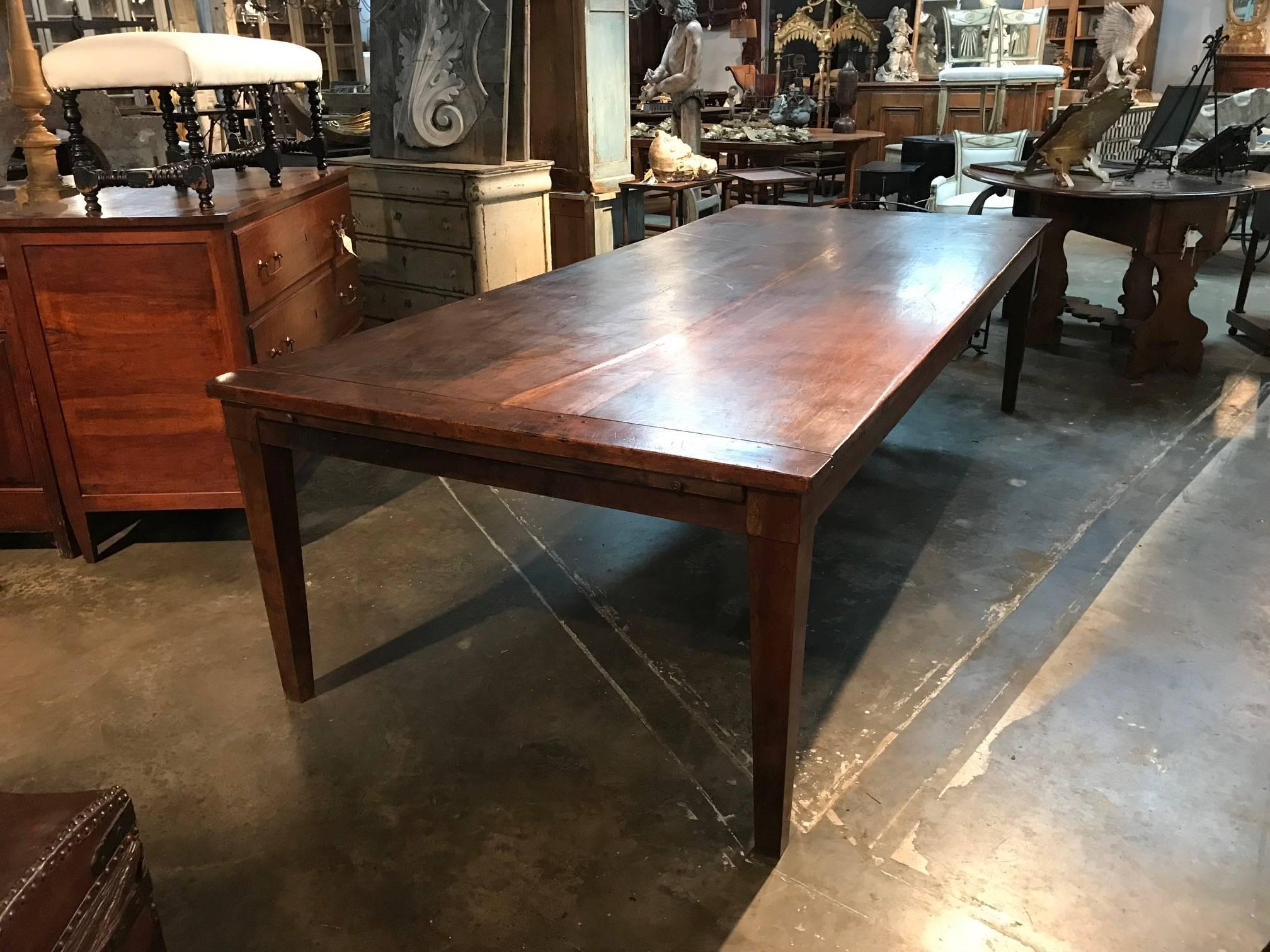 An outstanding grand scale table from Northern Italy. Soundly constructed from very thick planks of walnut. Designed in a classical farmhouse style. There are wonderful pullouts at each end of the table - extending the table substantially. The table