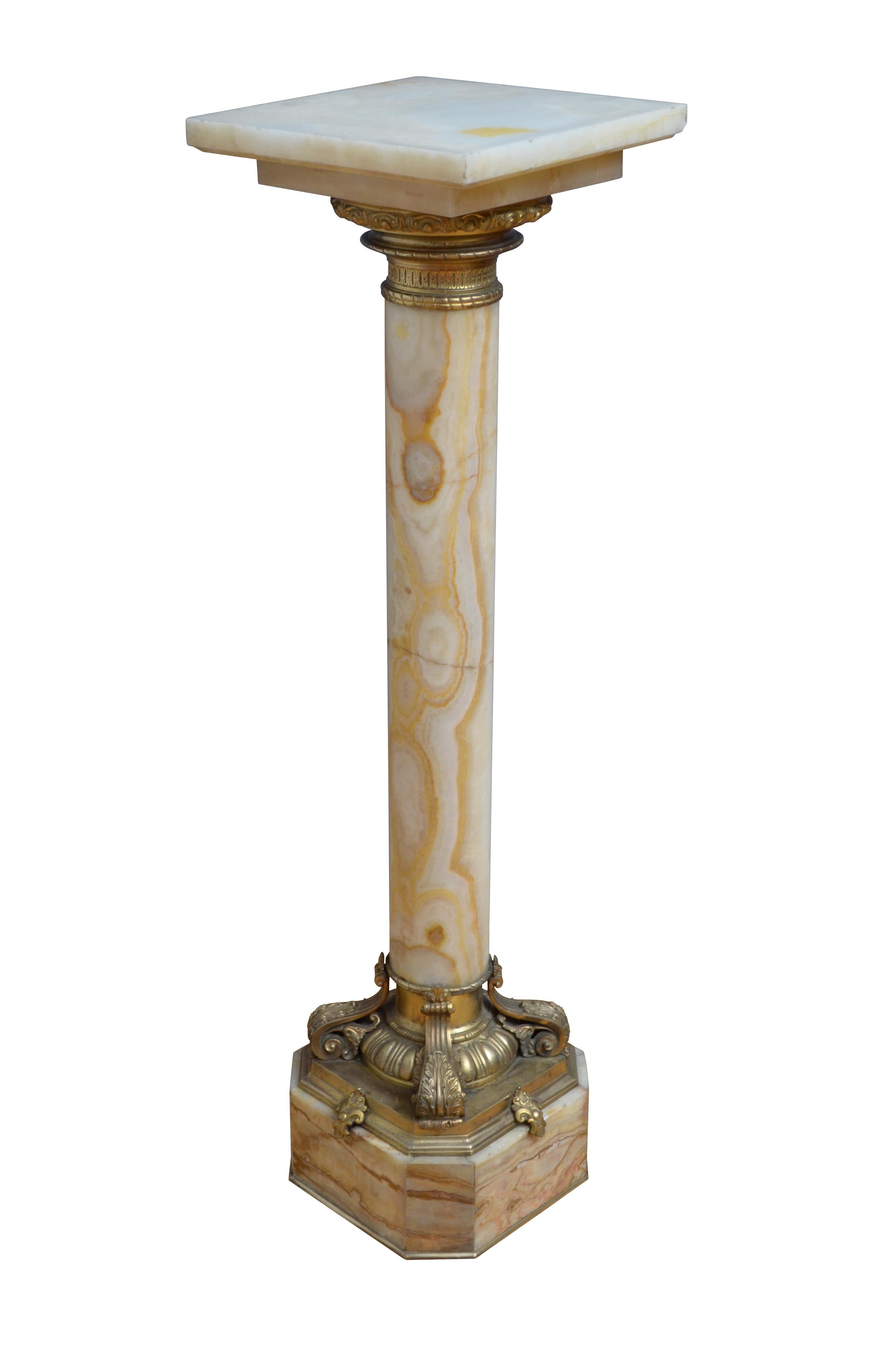 Remarquable piédestal en onyx du XIXe siècle, avec un plateau tournant et un collier en bronze doré en dessous, une imposante colonne aux couleurs variées se terminant par une très belle base à décor d'œuf et de fléchettes et quatre feuilles en