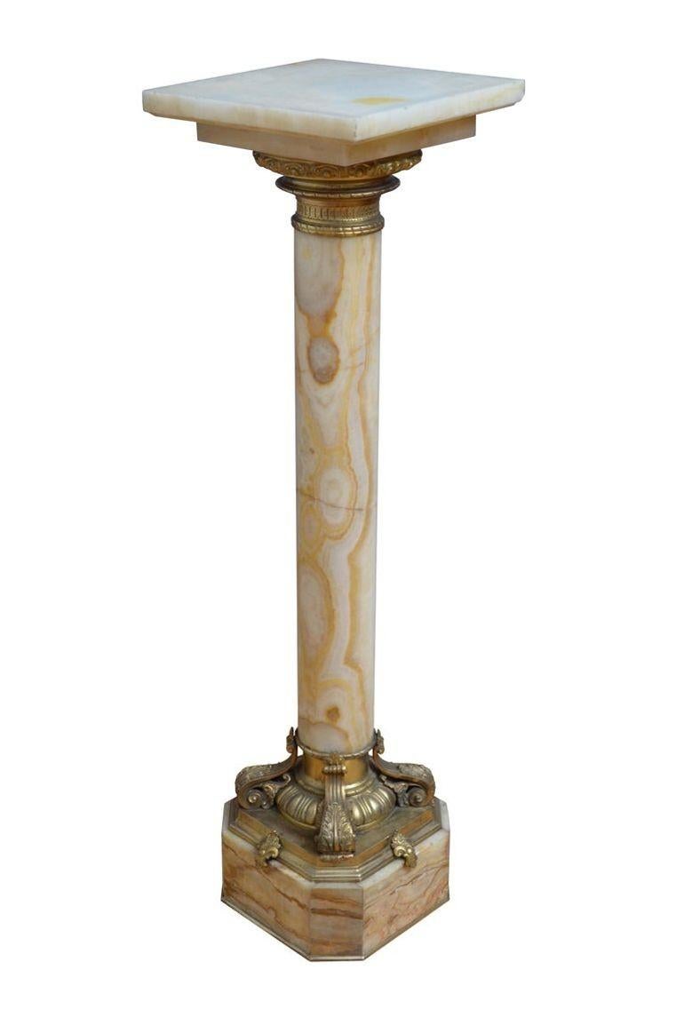 K0527 Outstanding XIXth century onyx pedestal with revolving top with ormolu collar below, substantial column with variety of colours terminating in most beautiful base with egg and dart decoration and four scrolled leaves, standing on canted base