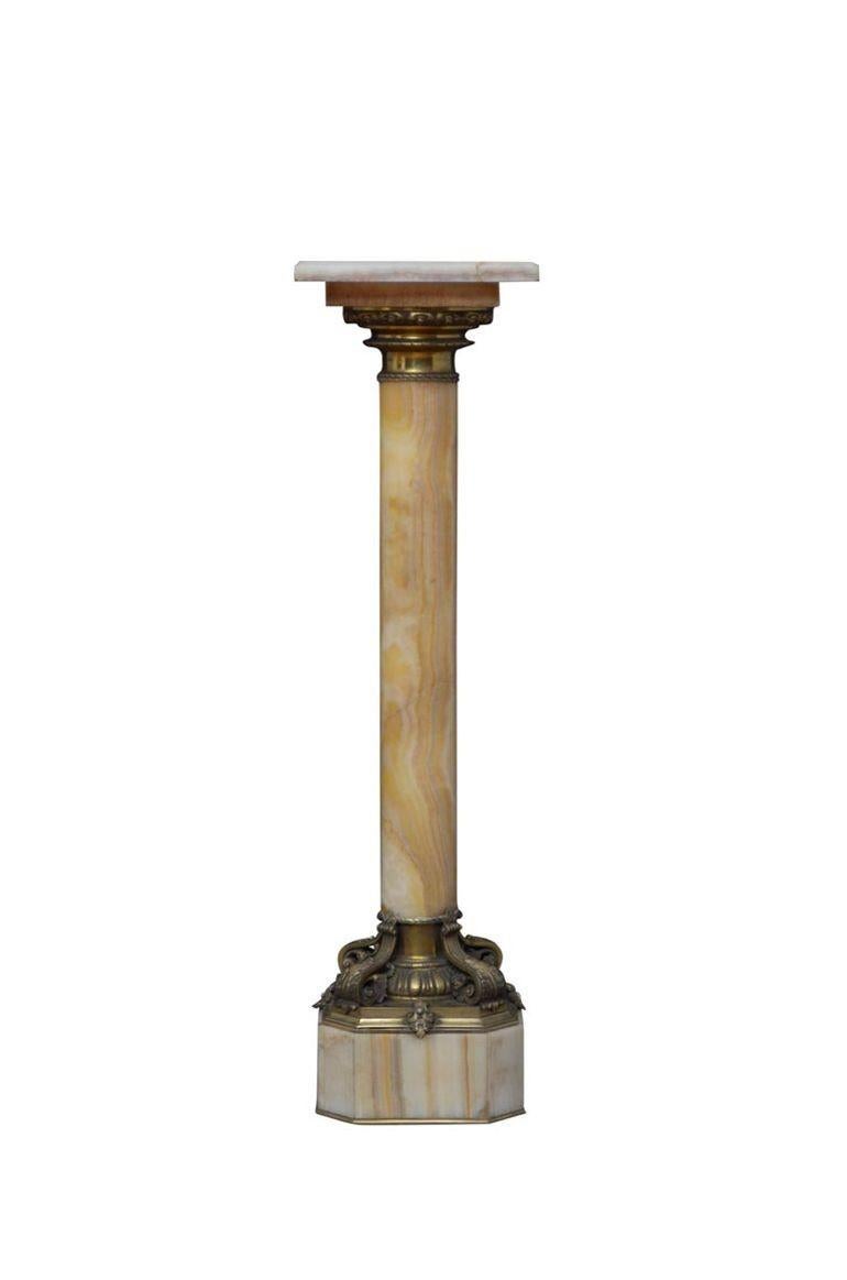 K0527   Outstanding XIXth century onyx pedestal with revolving top with ormolu collar below, substantial column with variety of colours terminating in most beautiful base with egg and dart decoration and four scrolled leaves, standing on canted base
