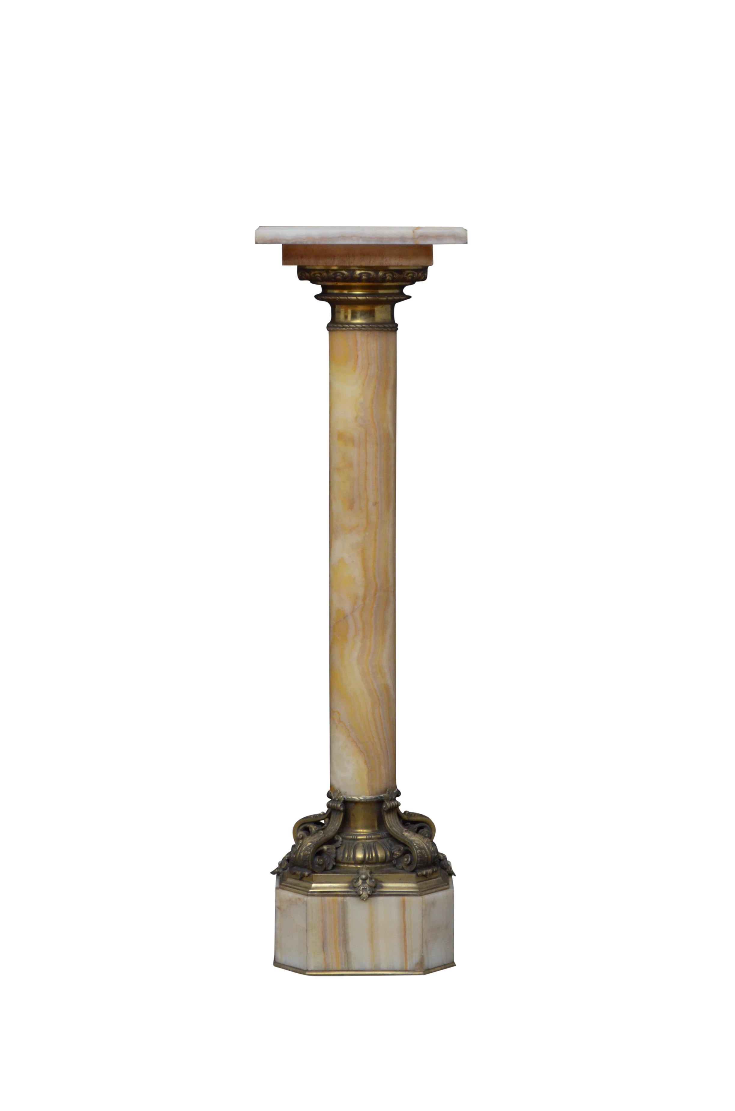 Outstanding XIXth century onyx pedestal with revolving top with ormolu collar below, substantial column with variety of colours terminating in most beautiful base with egg and dart decoration and four scrolled leaves, standing on canted base and