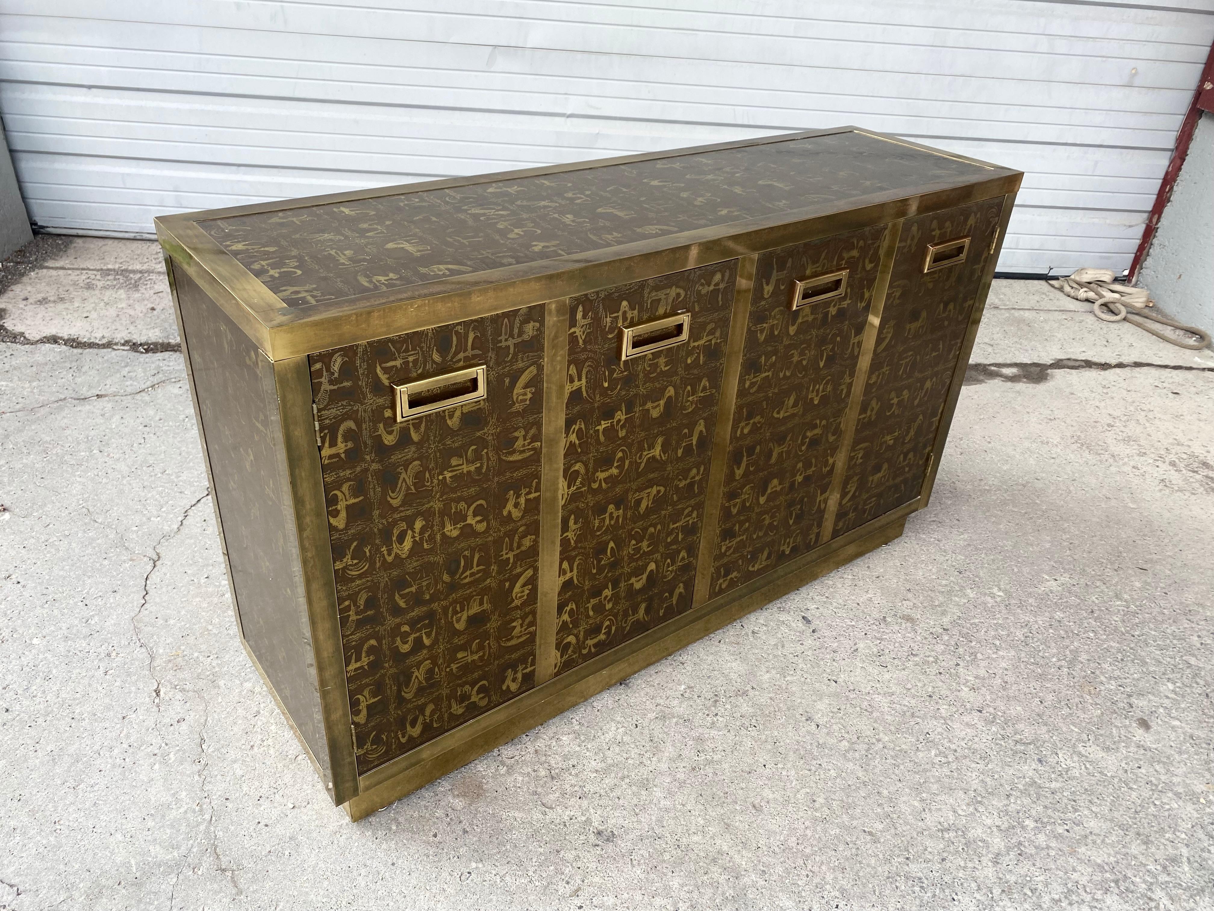 Outstanding acid etched brass cabinet by Bernard Rohne for Mastercraft, 2 door sideboard /cabinet. Dry bar, exceptional acid etched brass with brass pulls housed in a brass frame. Asian inspired motif, designed by Bernhard Rohne for Mastercraft.,