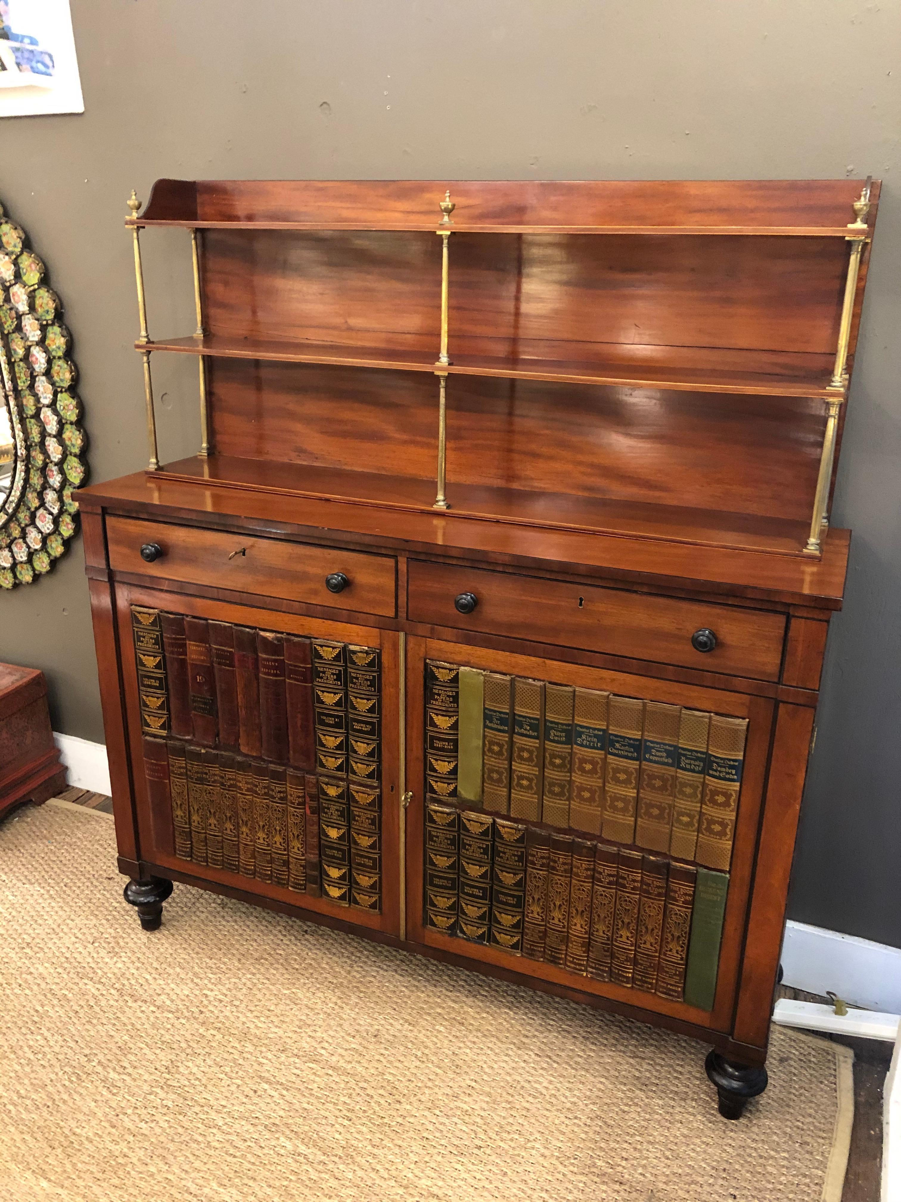 Wonderful character rich 19th century mahogany chiffonier cabinet having tromp l'oeil leather books on the fascade of the the lower cabinet (49.5 W 14 D 36 H) with lined adjustable shelf within and two drawers above. The top shelves rest on bottom