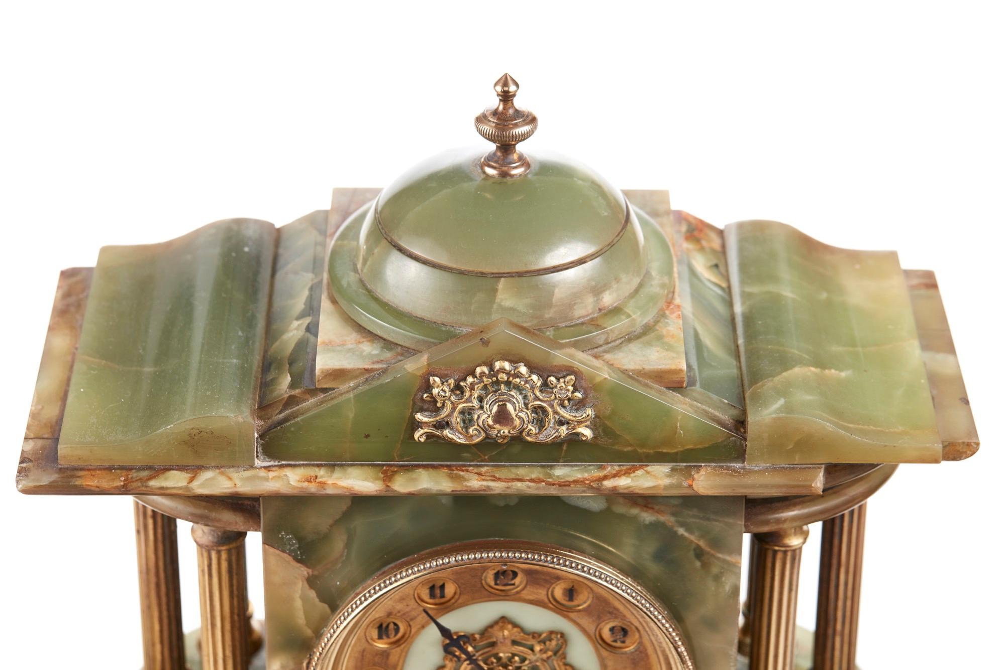 Outstanding antique French clock set, the clock is a beautiful green onyx with gilded mounts. 8 day French movement striking on a bell. Shaped top, Corinthian column supports standing on a plinth base. The matching urns are also made of beautiful