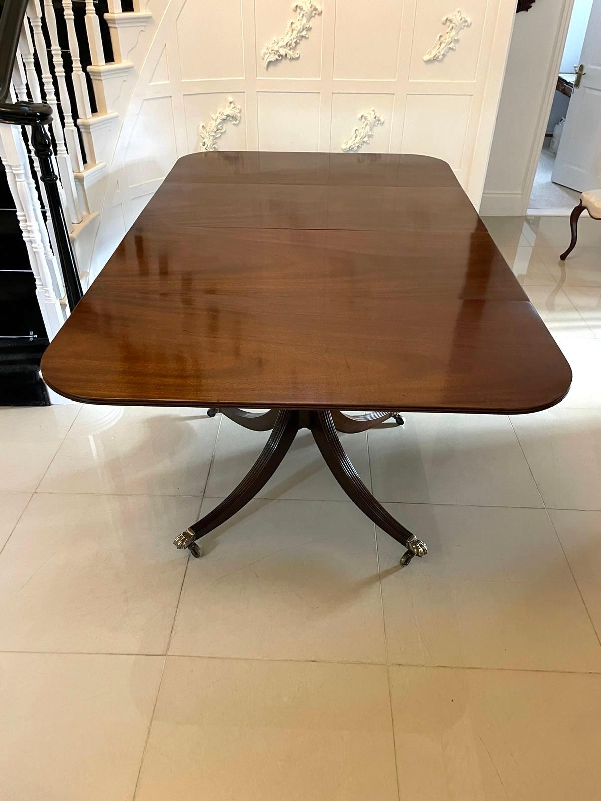 Outstanding antique Victorian 14 seater figured mahogany dining table having an exceptional solid figured mahogany top with a reeded edge, two original extra leaves and supported by two elegant turned mahogany pedestal columns standing on splayed