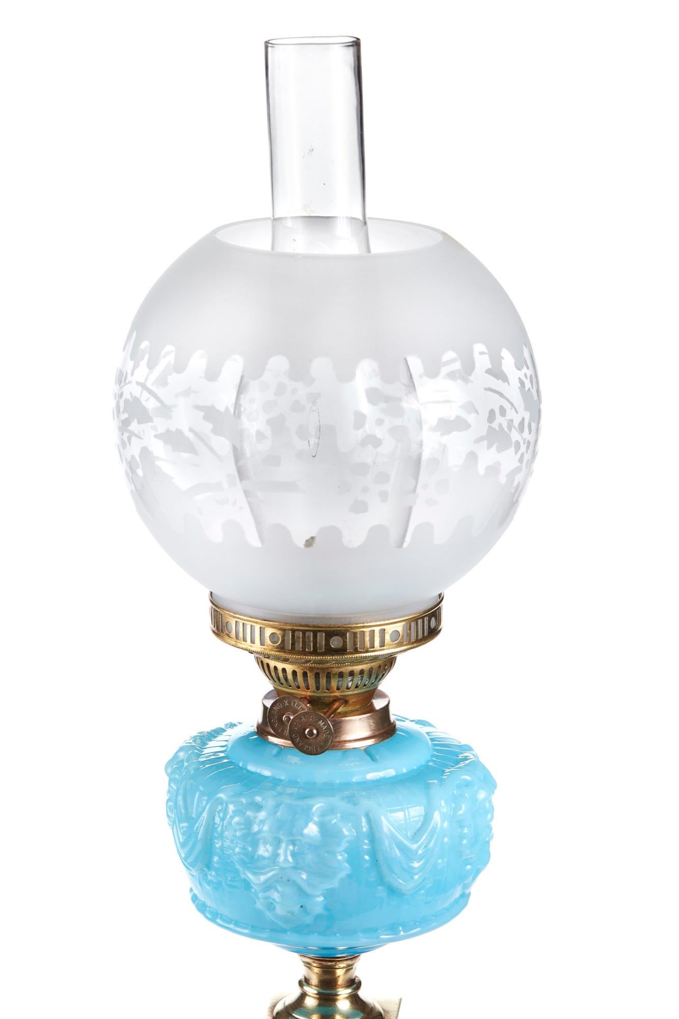 This is an outstanding 19th century Victorian antique brass Corinthian column oil lamp with stepped square base with reeded column, blue font, duplex burner, etched glass shade and original chimney.